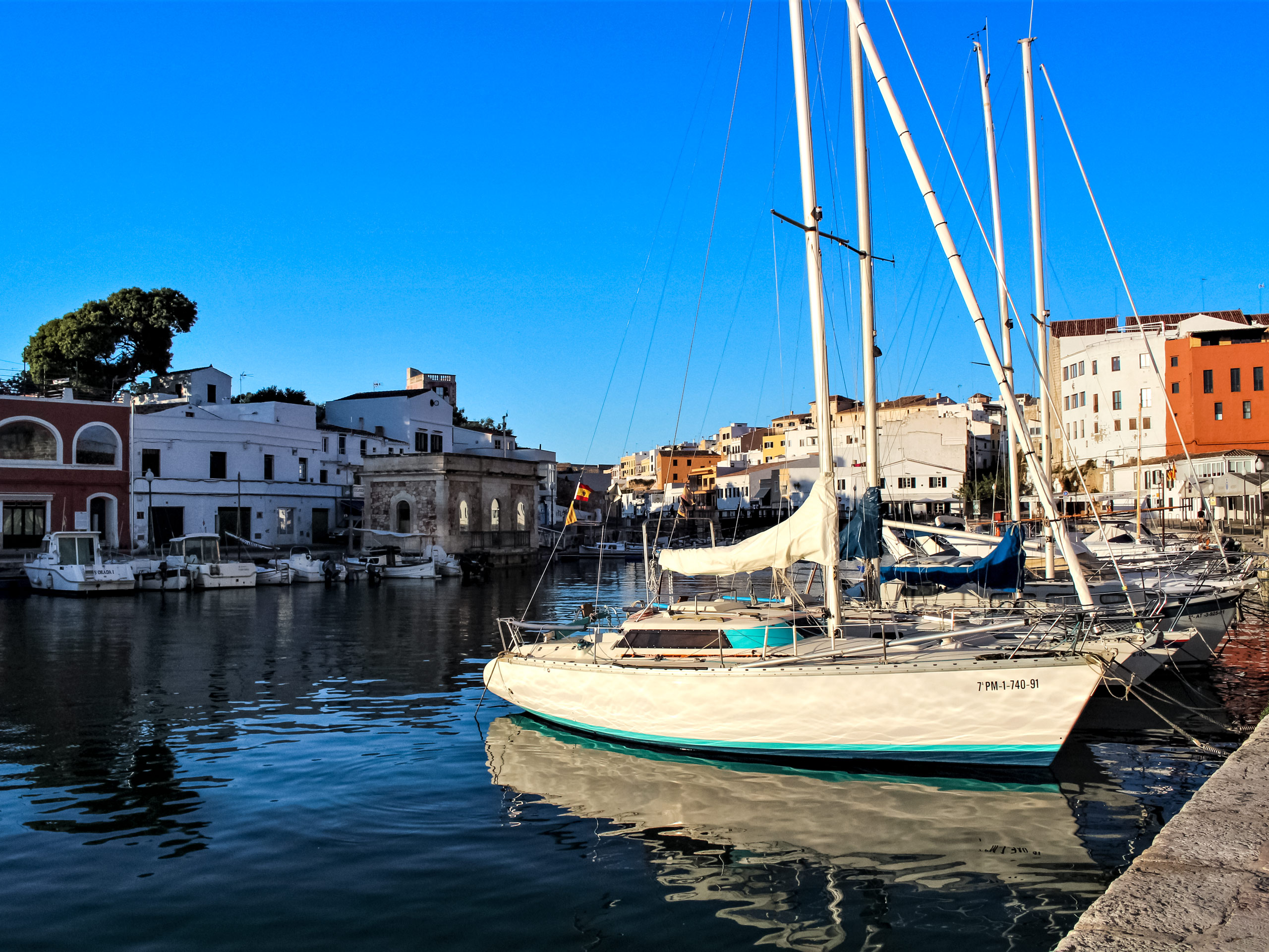 Sail boats in the harbour walking tour Menorca Spain