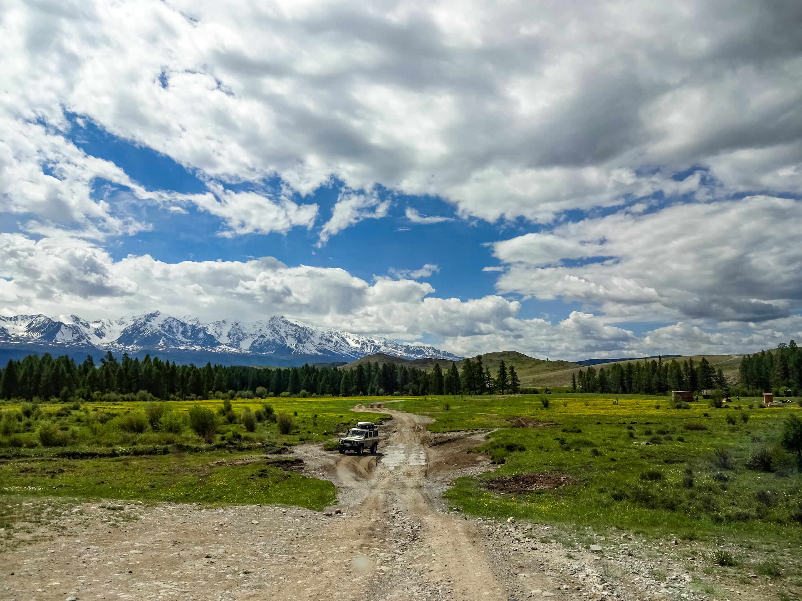 Safari jeep all terain vehicle parked on dirt access road in Altai mountains Russia