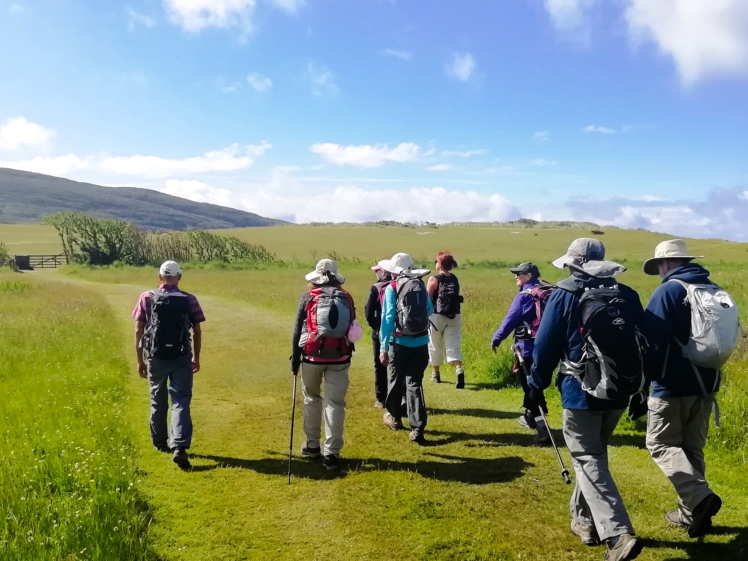 Tourists group walking on the Ireland hills