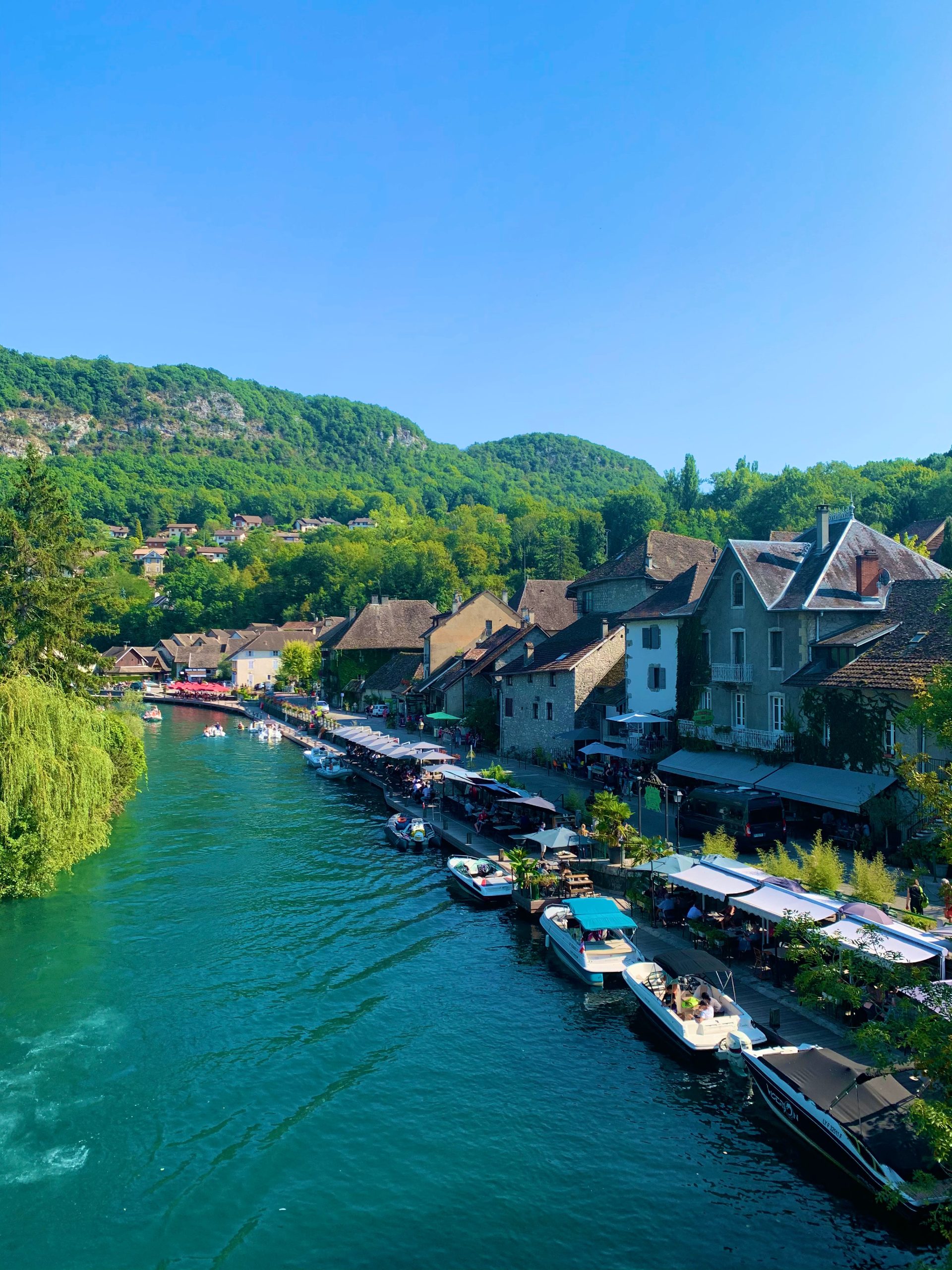 Boats along the river in small French town, visited on biking tour