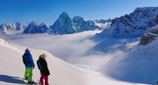 Two snowboarders in Bella Coola mountains (partially-guided heli ski tour)