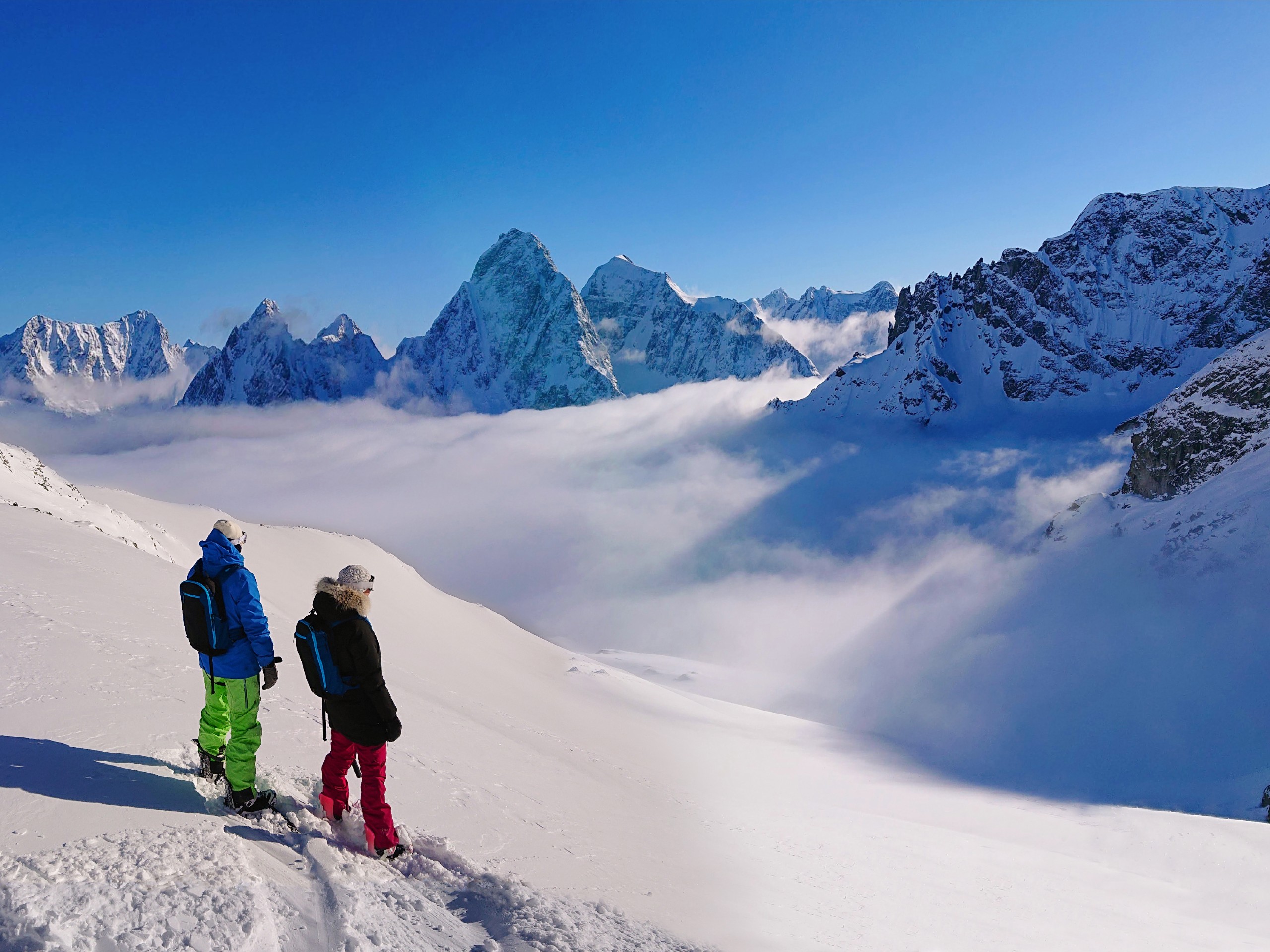 Two snowboarders in Bella Coola mountains (partially-guided heli ski tour)