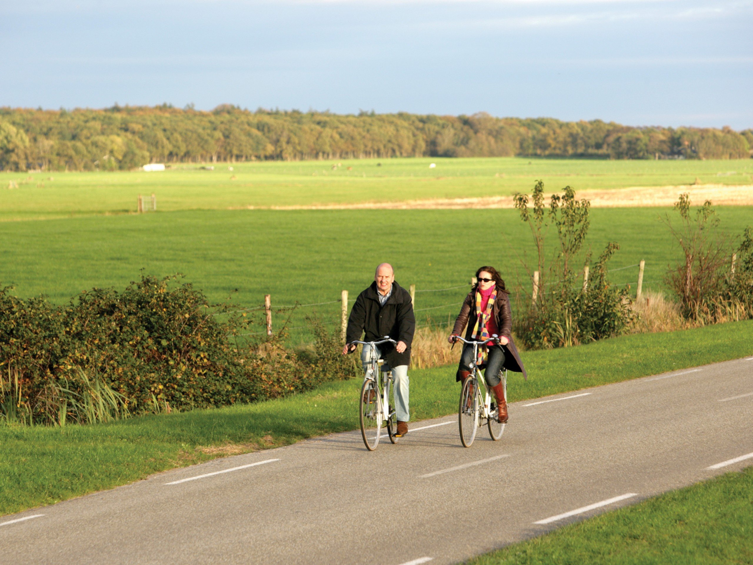Couple riding a biking path in November