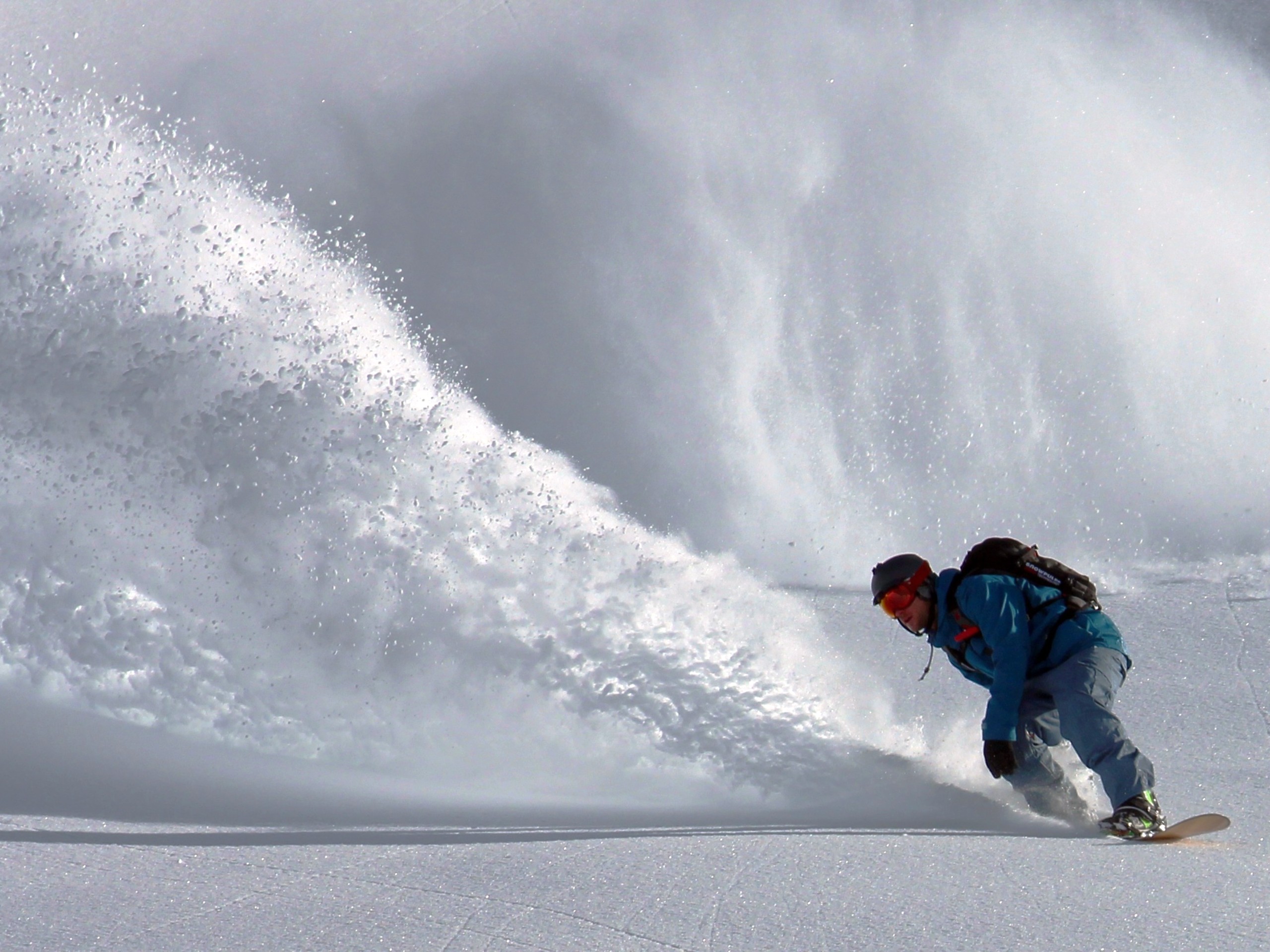 Snowboarder skiing down the mountain in Bella Coola