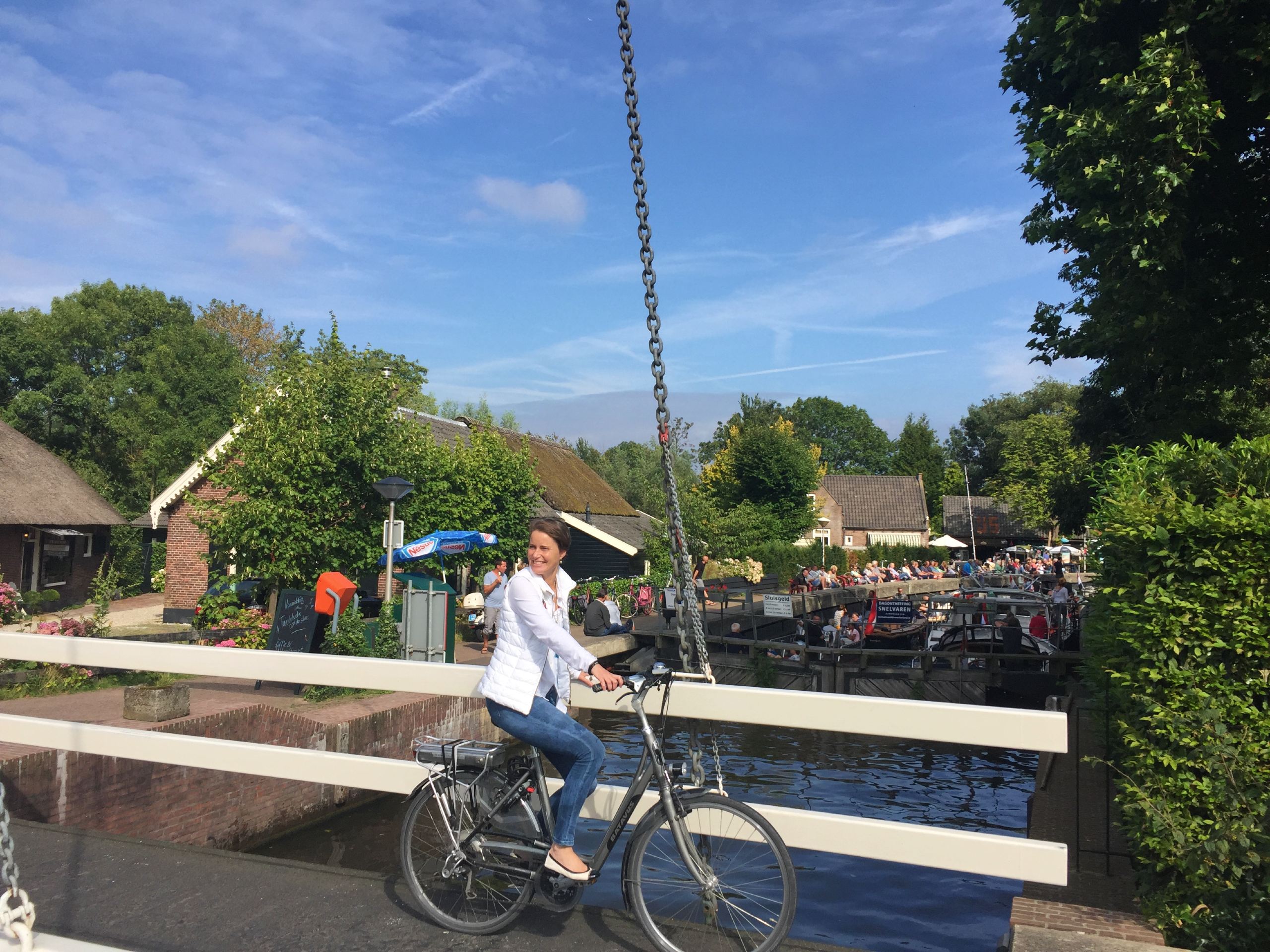 Lady crossing the bridge on a bike in Vecht