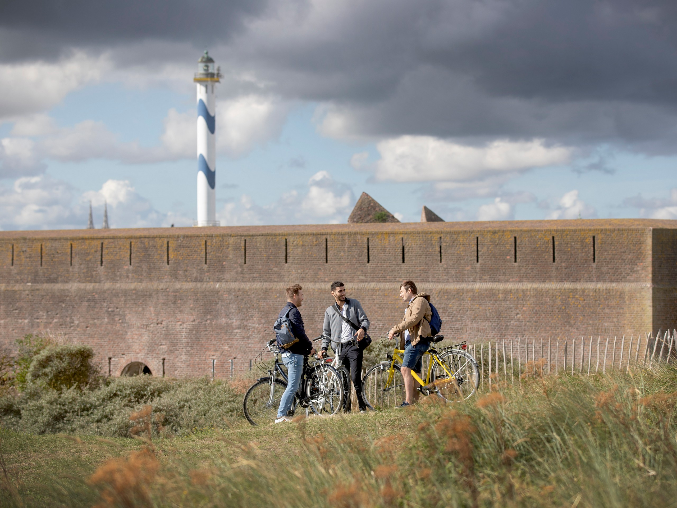 Three bikers in Flanders, enjoying the local architecture