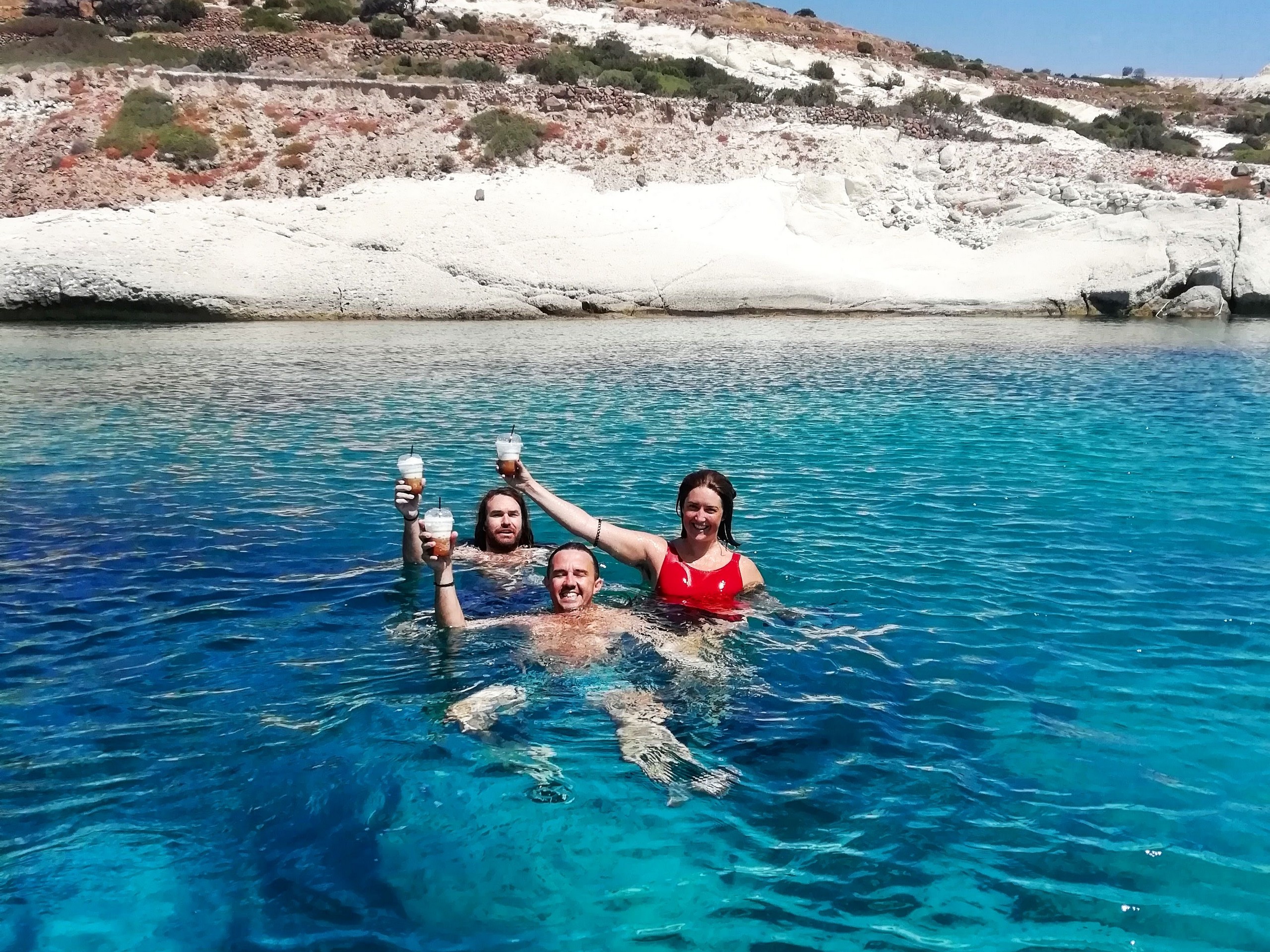 Group of travellers swimming in turquoise waters near Kythnos