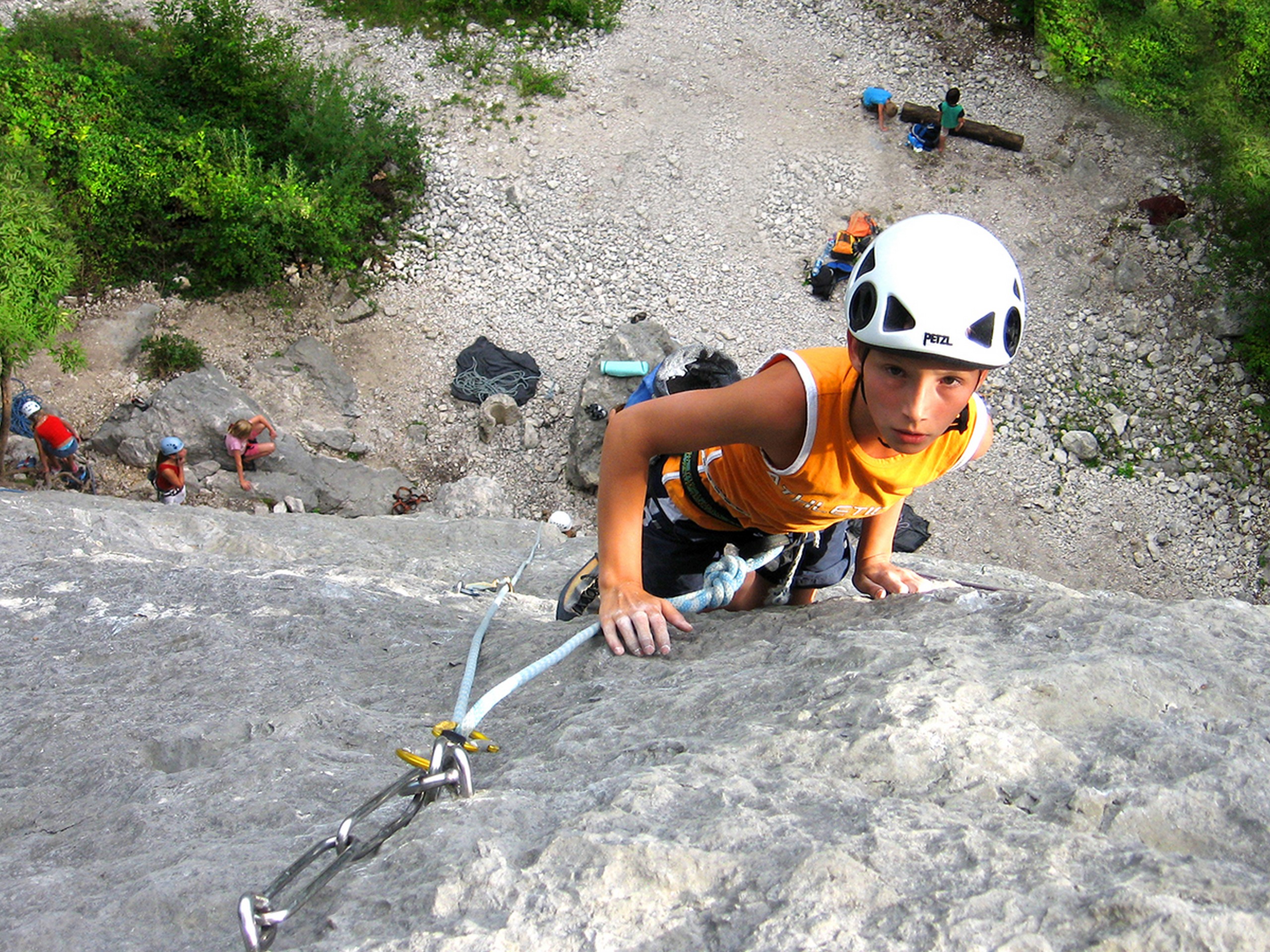 Boy climbing the rock wall in Slovenia