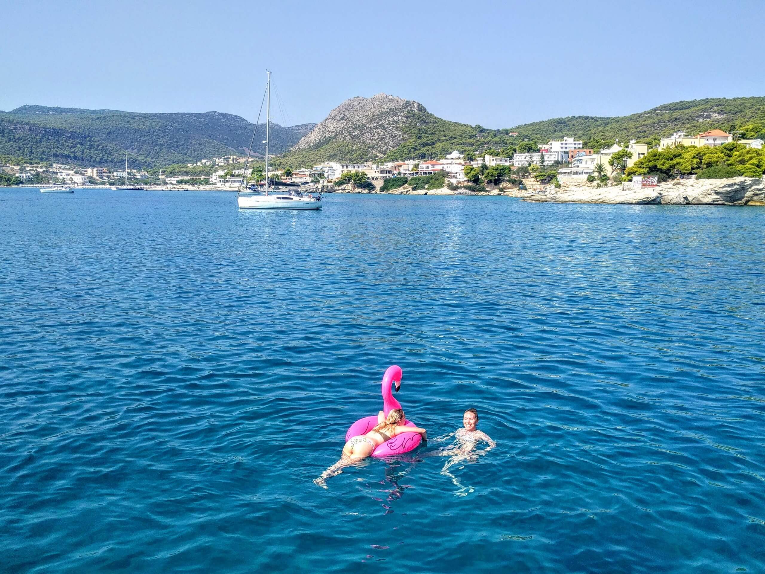 Two girls swimming in Aegean sea whileon a sailing tour