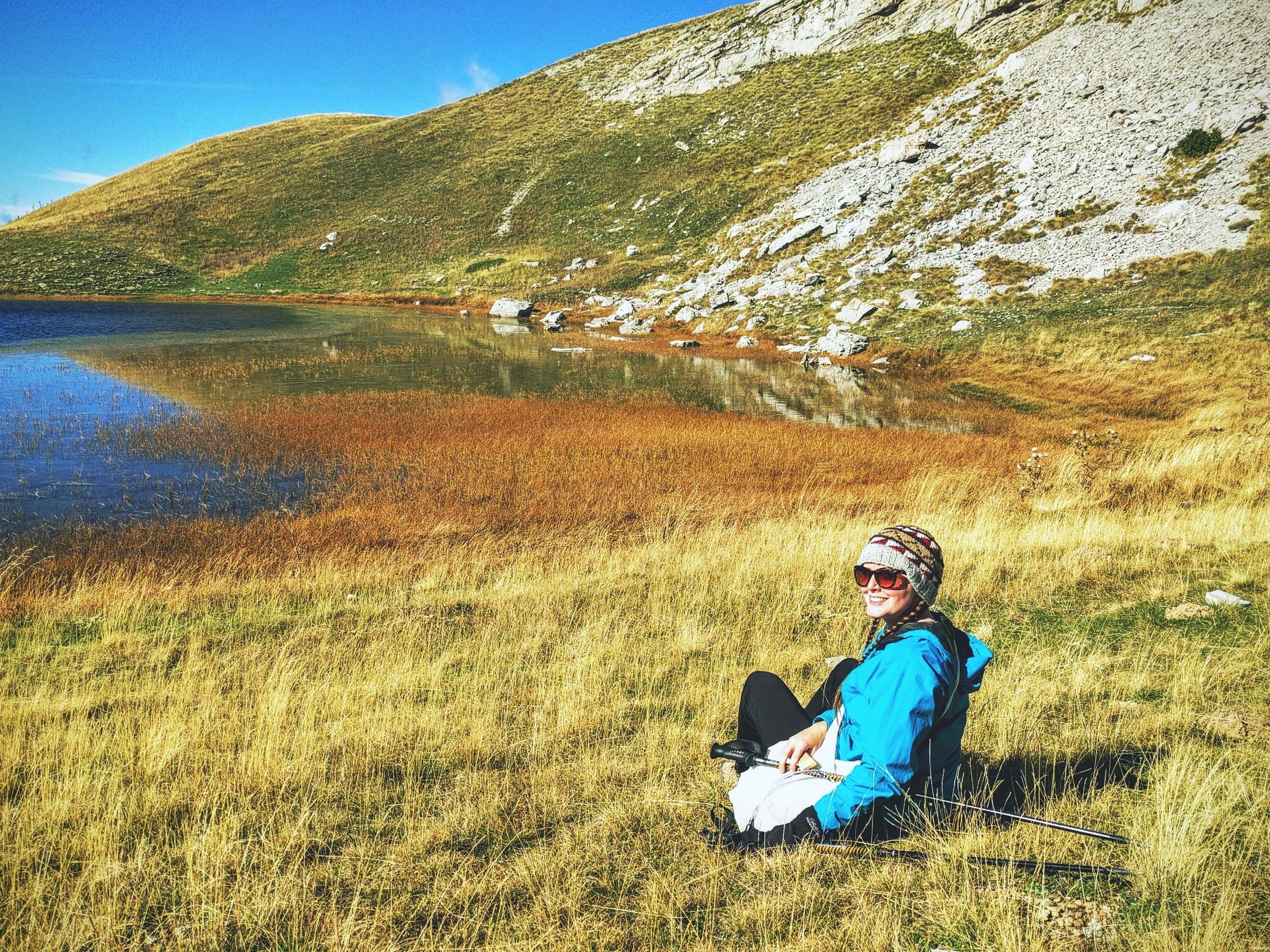Hiker having a rest near the small lake in Greece