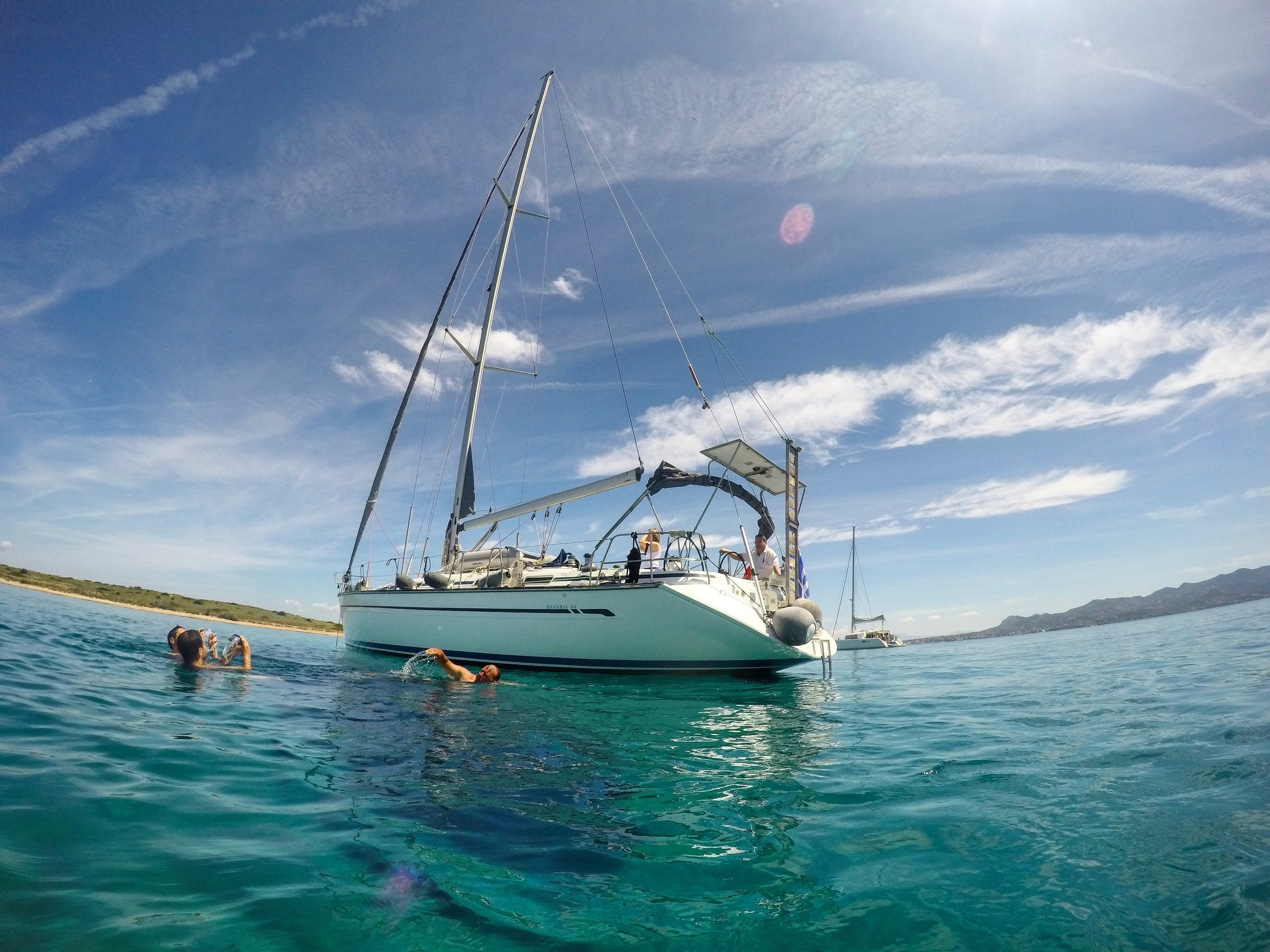 Sailboat in turquoise waters near the shores of Greece