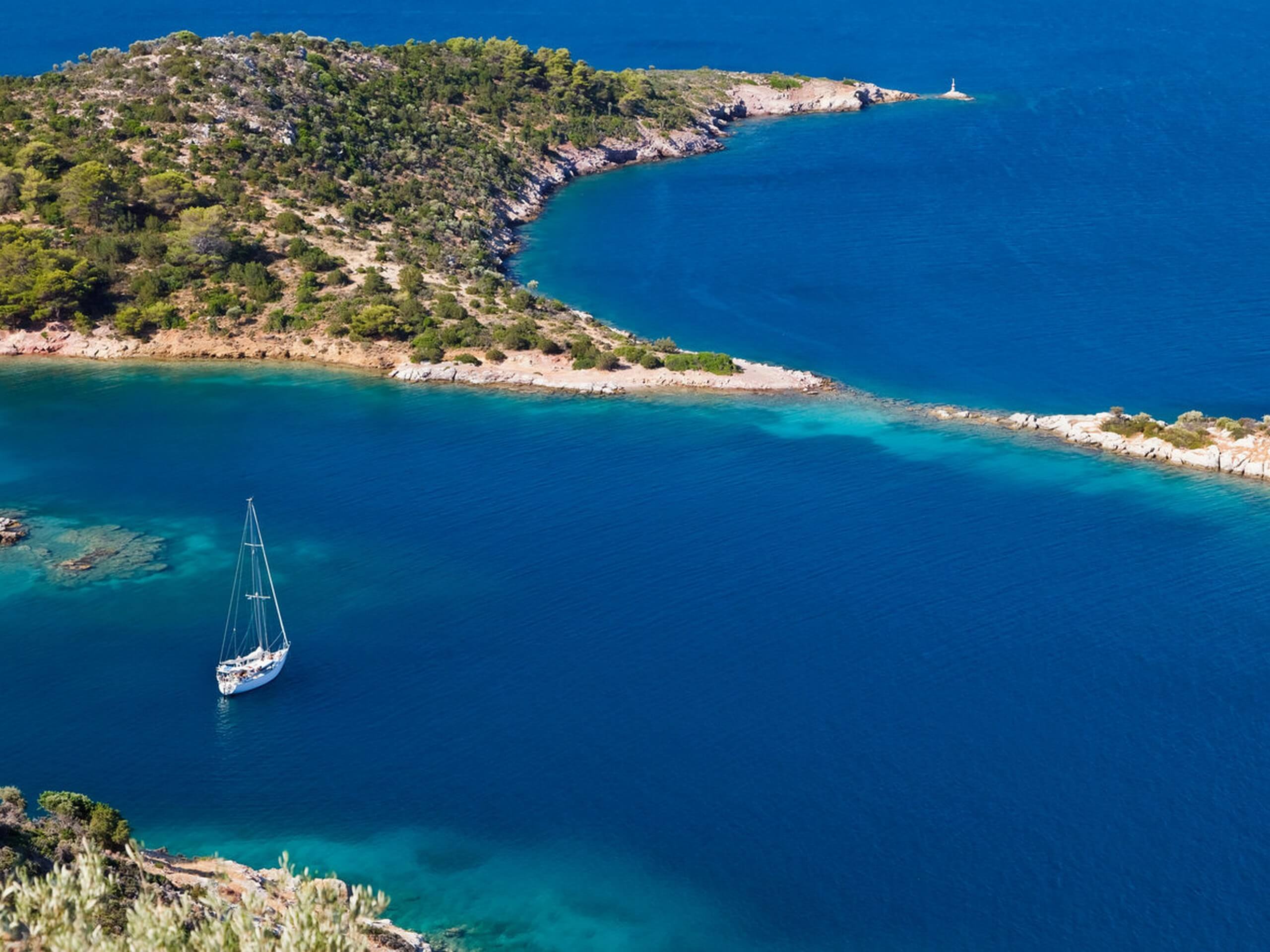 Sailing boat in blue waters of Poros