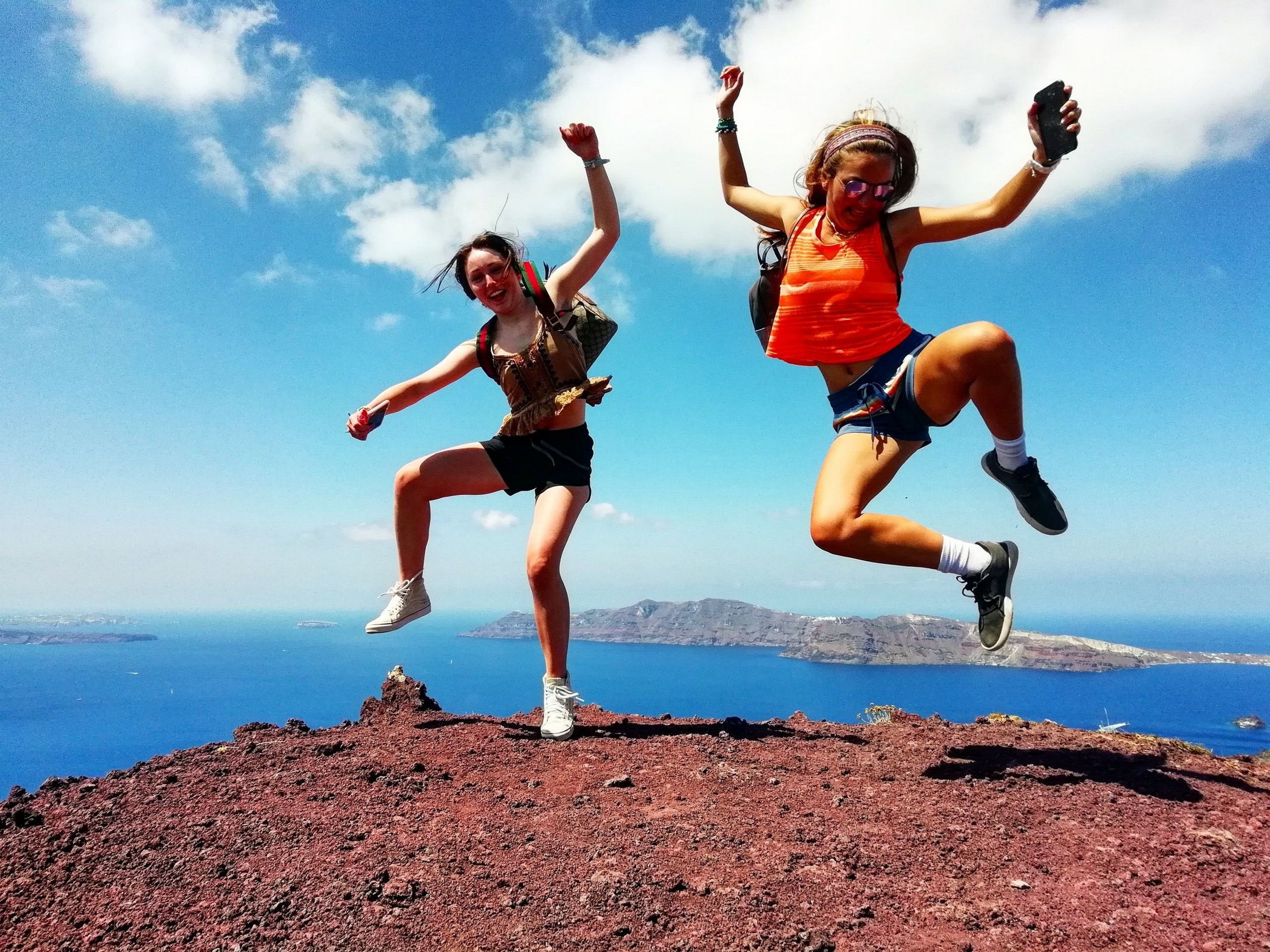 Two adventurers on top of the mountain in one of the Greek Islands