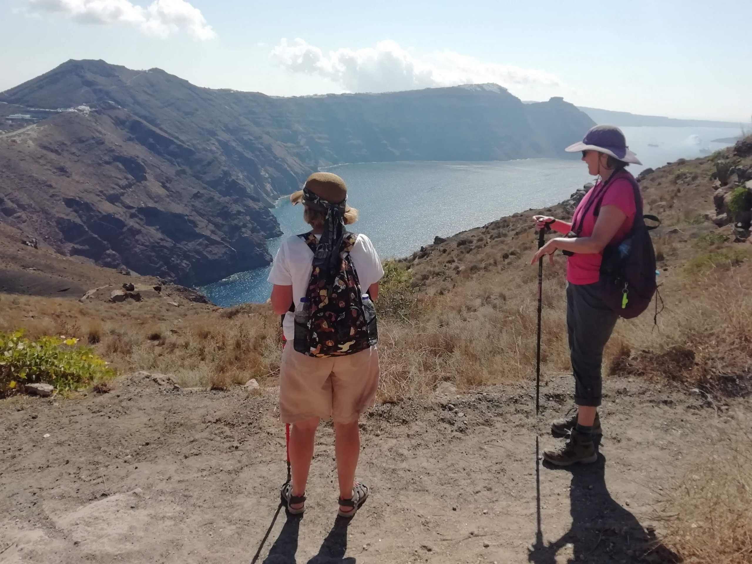 Two hikers observing the horizons while on Multisport tour in Cyclades Islands