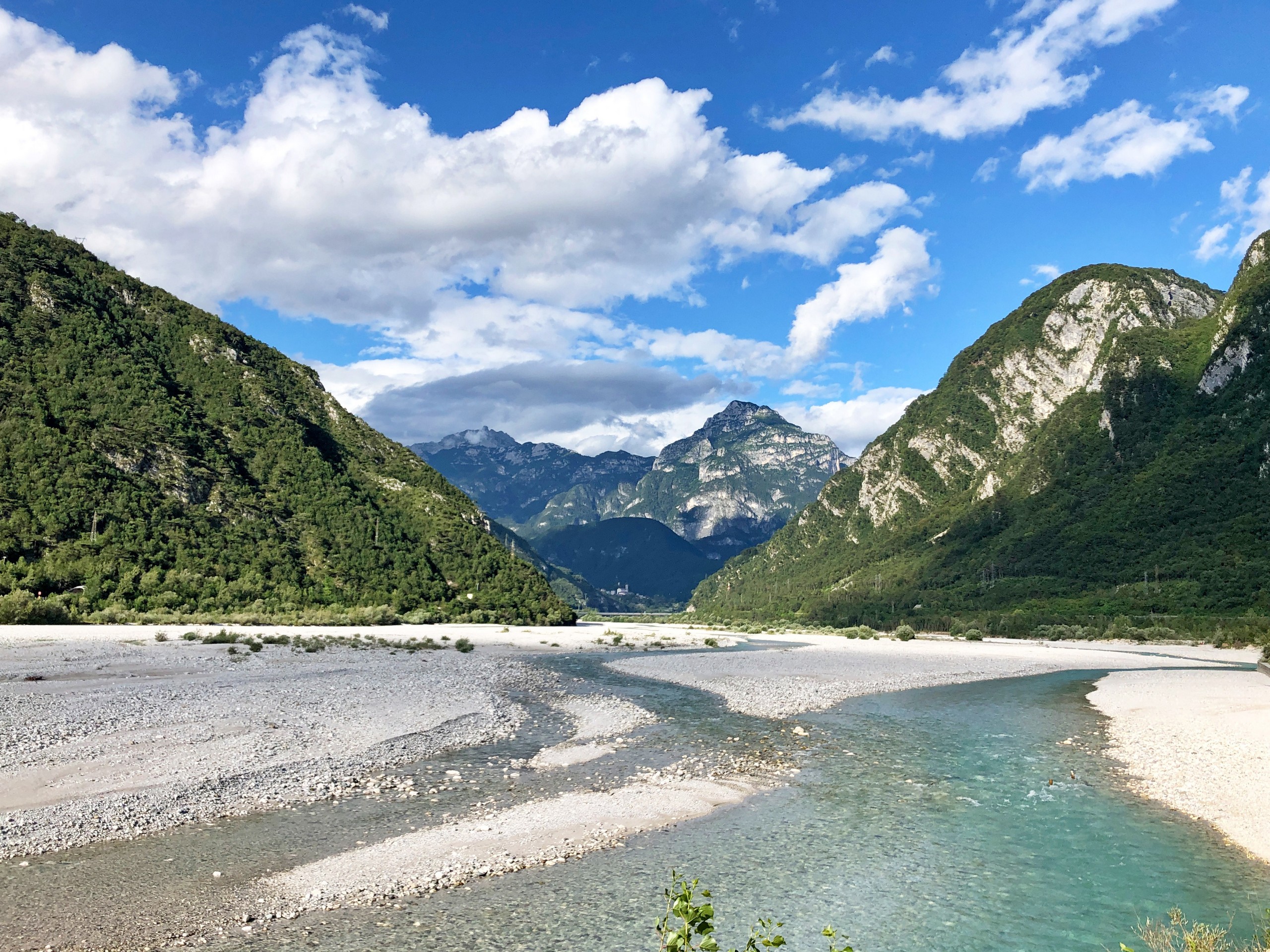 Wide riverbed in Alps, seen while biking on Alpe Adria trail