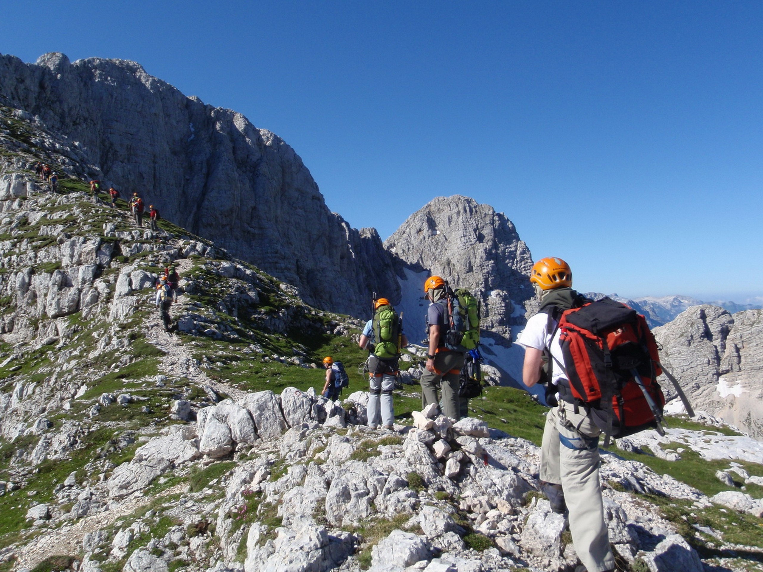 Group of hikers with a guide ascending to Triglav