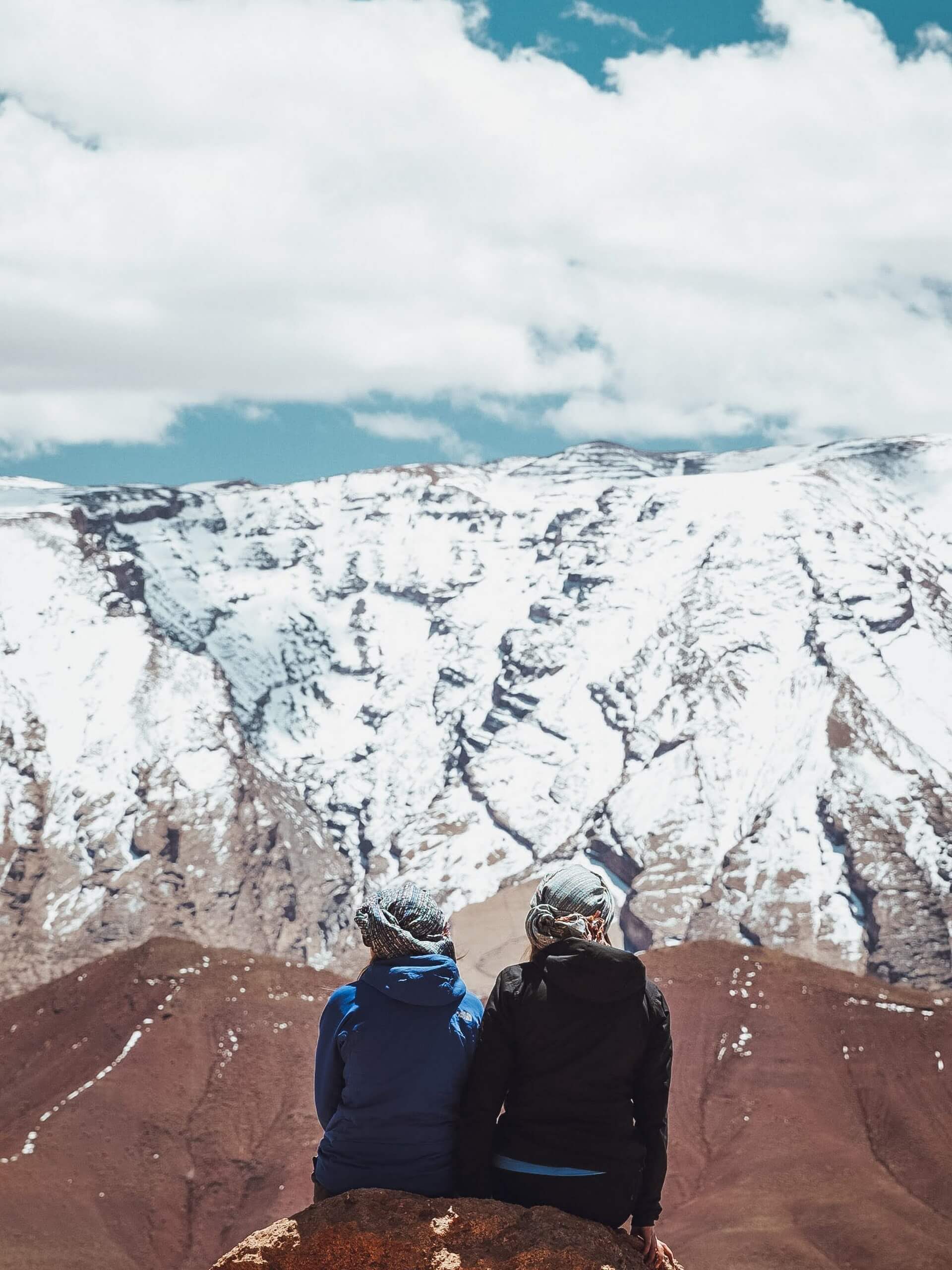 Couple looking at snowed in mountains in Morocco