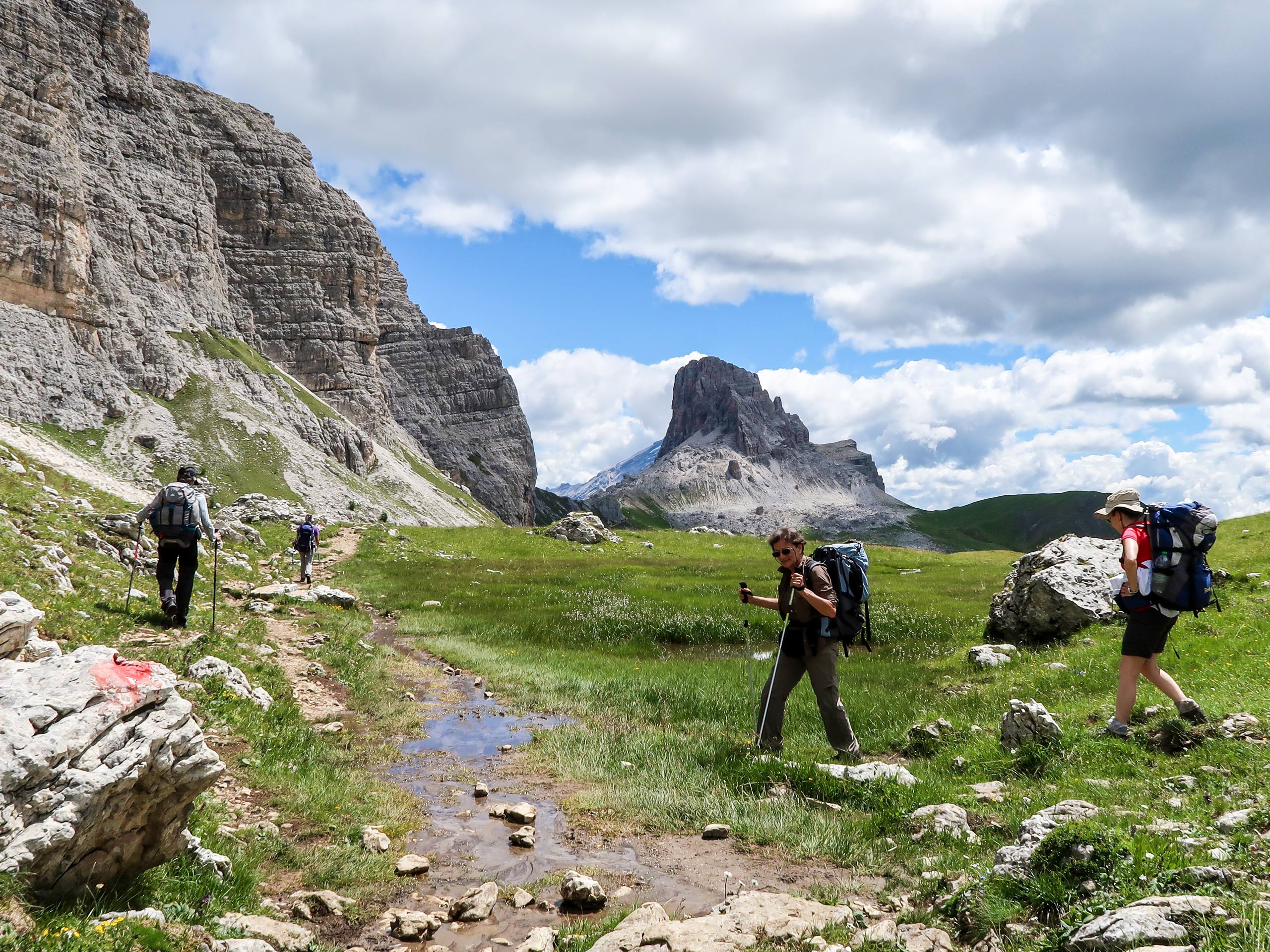 Group of tourists traveling in Dolomites mountains