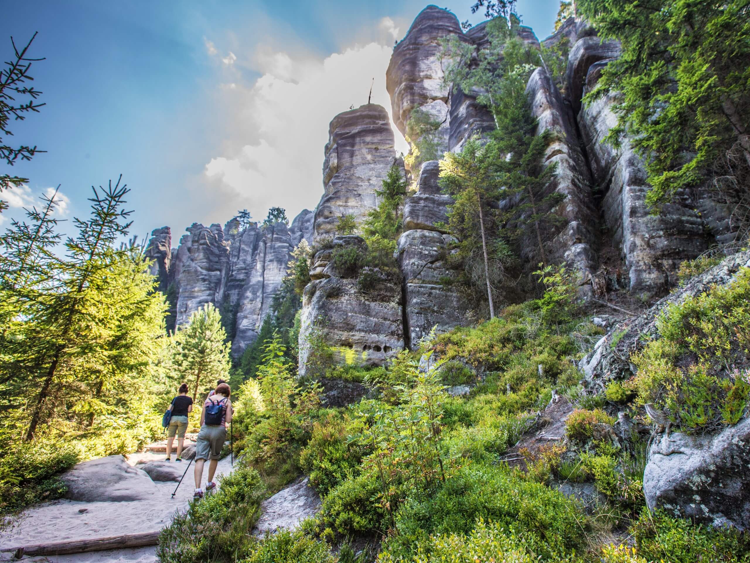 Hikers walking up among the rock formations in the Bohemian Paradise
