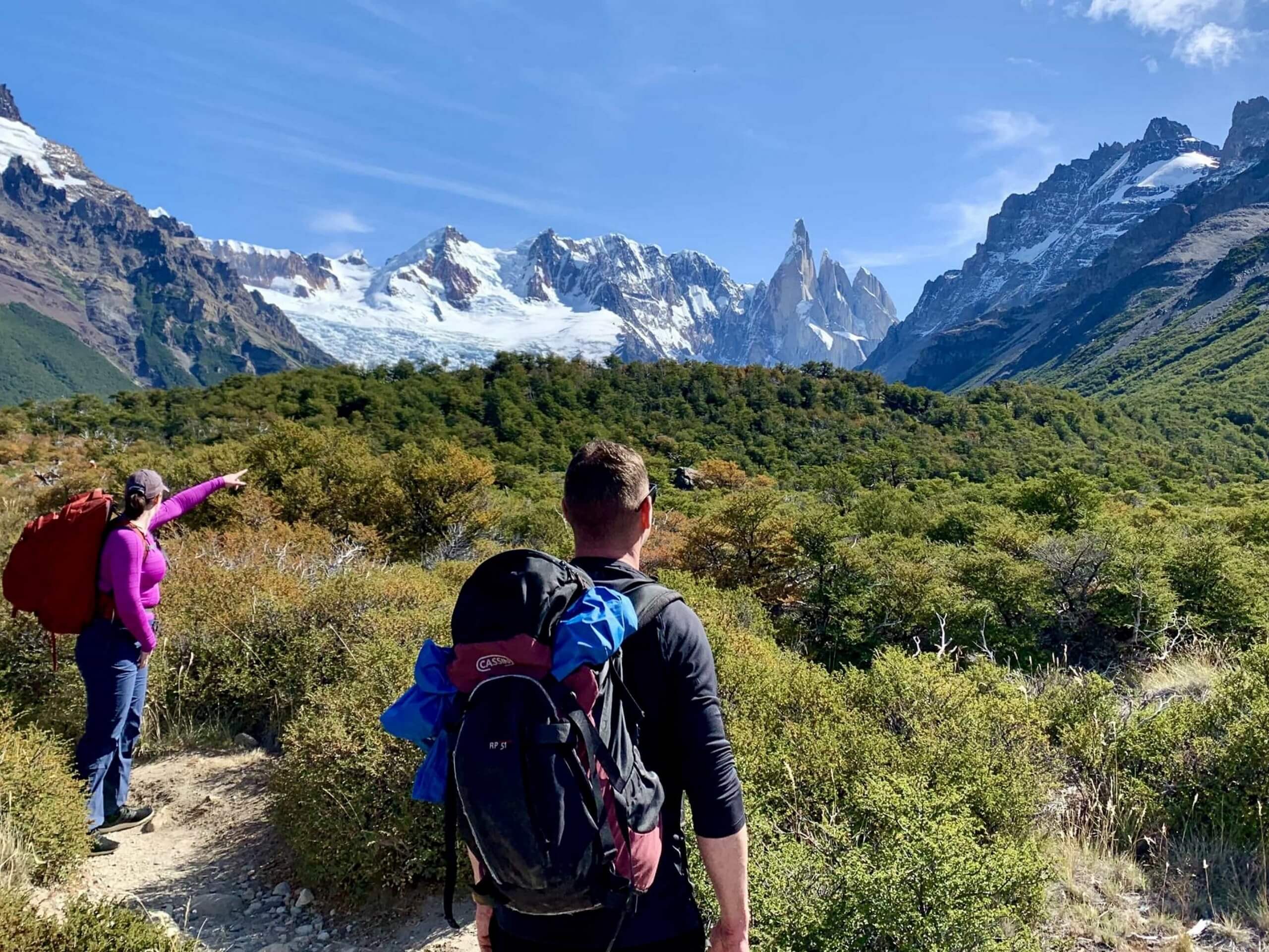 Group of hikers point at mountains in Patagonia