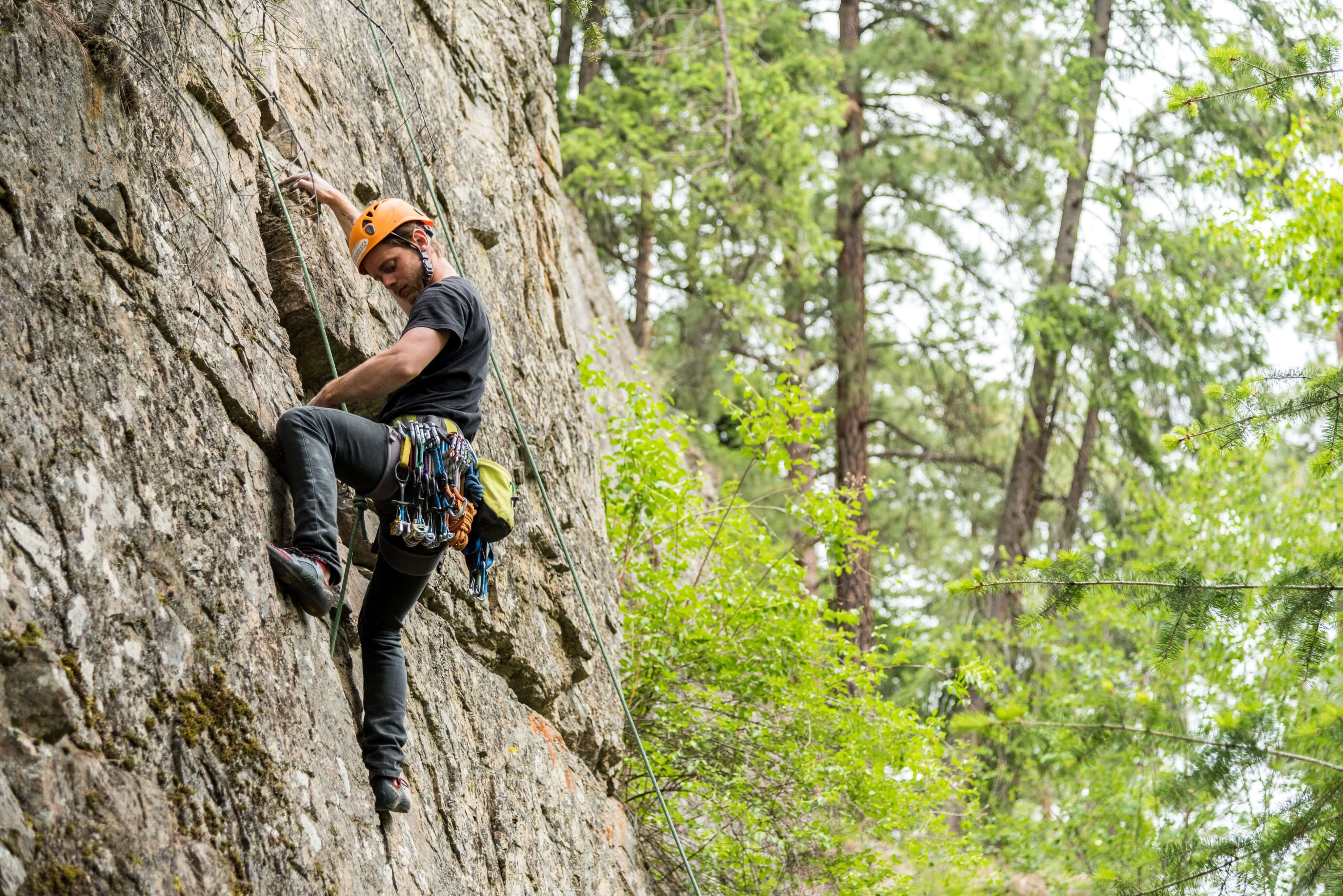 Rock cliber on vertical rock wall in the Canadian Rockies