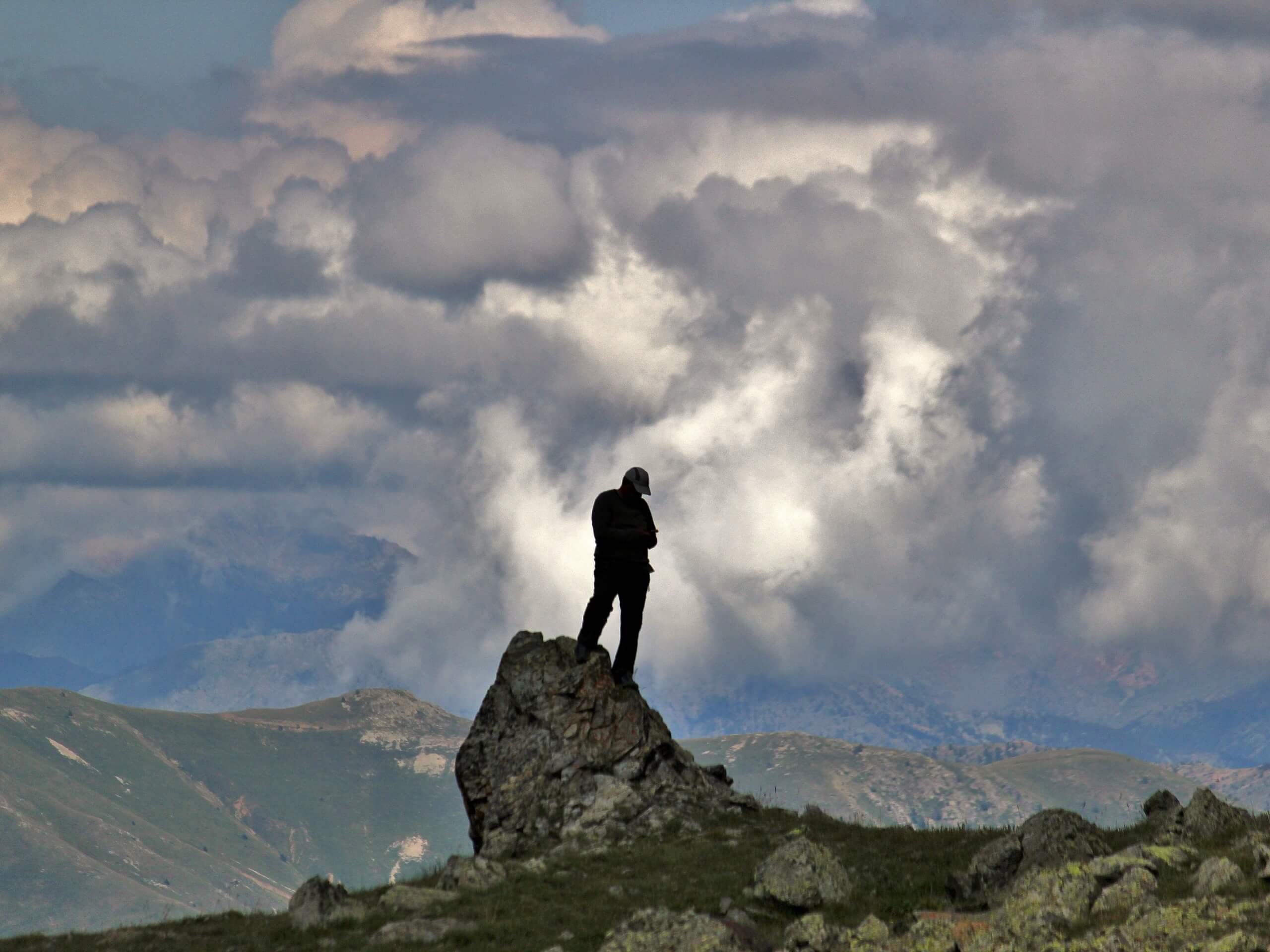 Hiker on top of big rock in Pontic Alps, Turkey