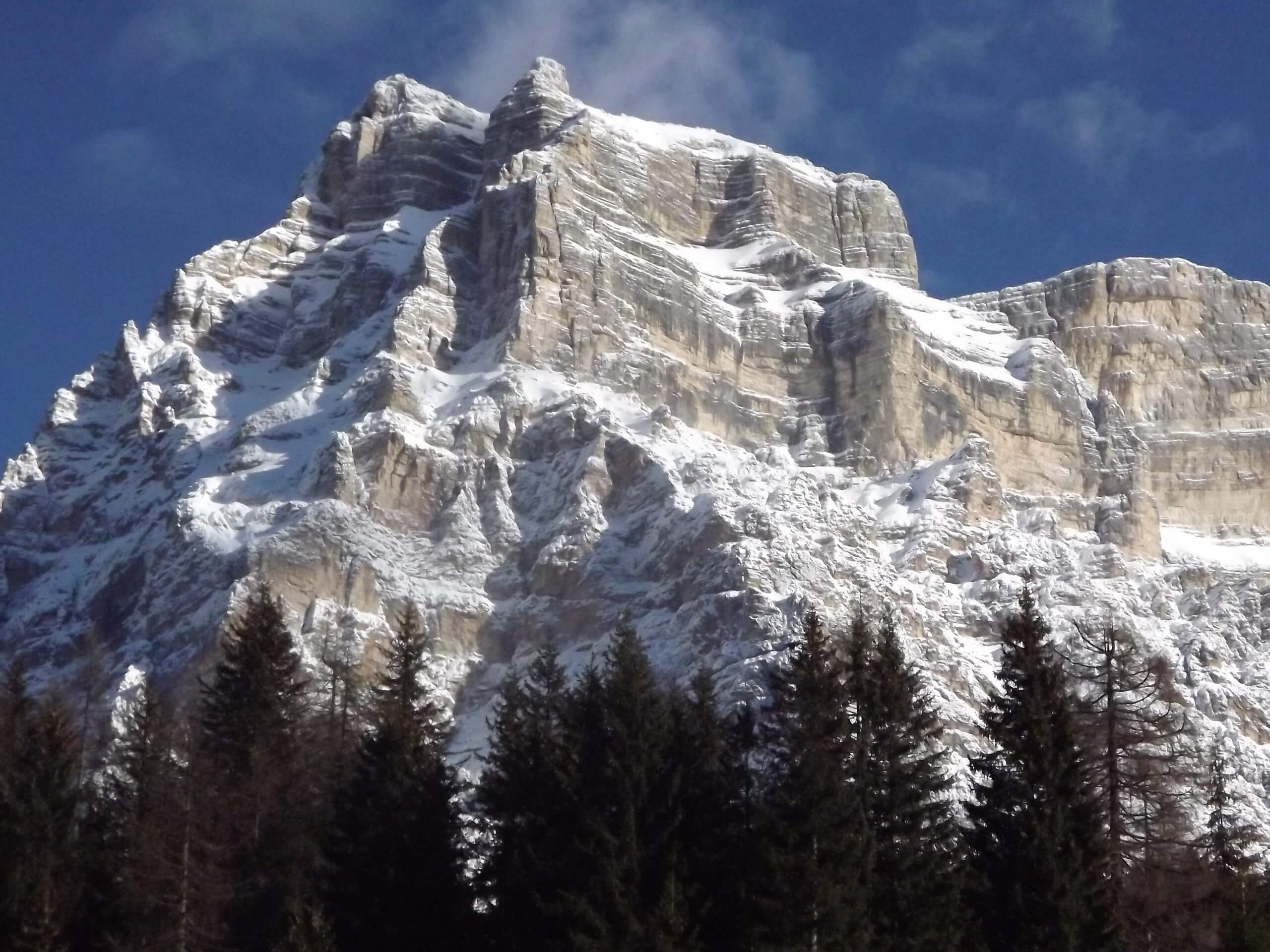 Beautiful rocky mountains in Dolomites covered by snow