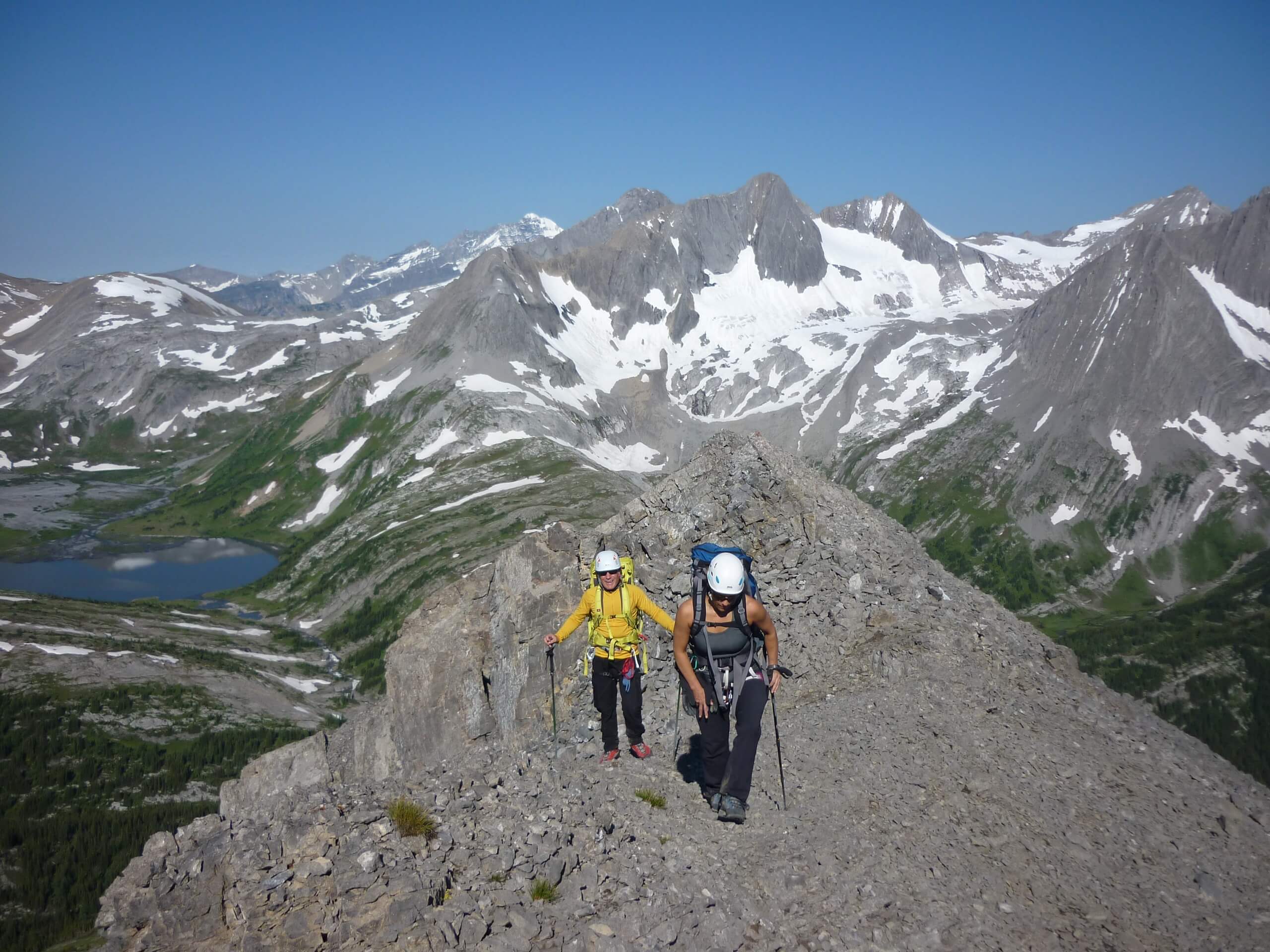 Three hikers on the peak in Kananaskis Country