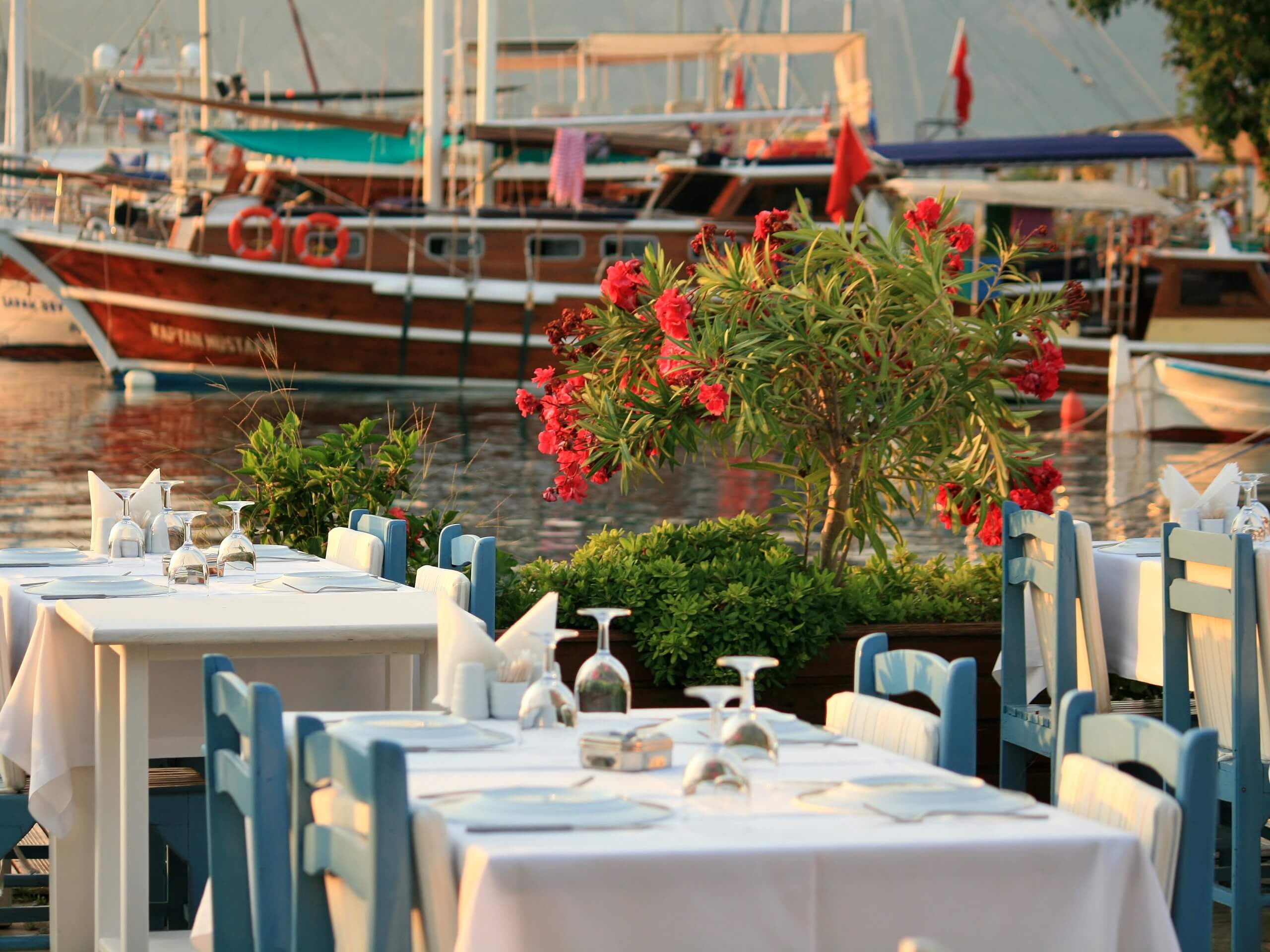 Nicely set table in the marina in front of gullets