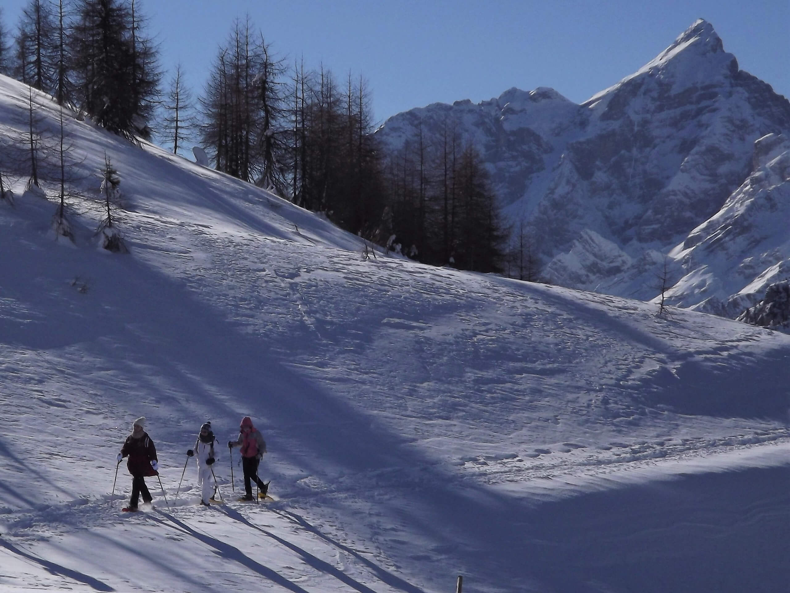Three snowshoers in the Dolomites