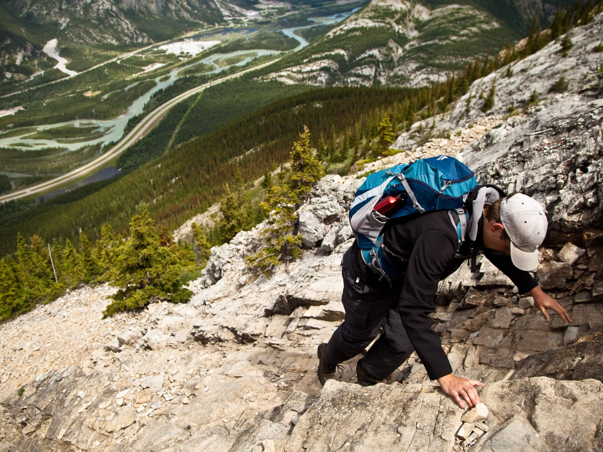 Scrambler on the ascend on a steep cliff