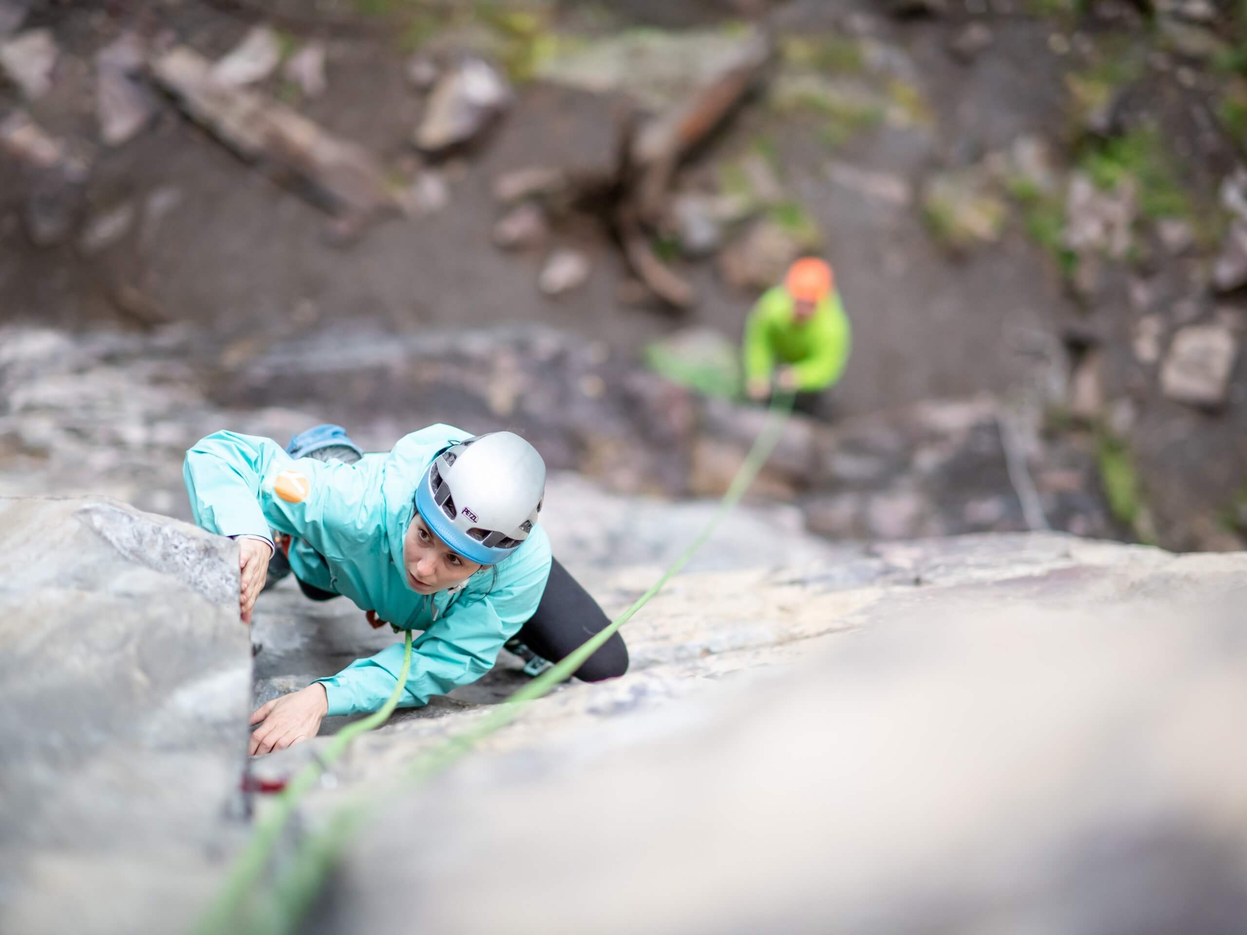 Woman climbing up on a rock climbing course, photo by @evazolaphoto