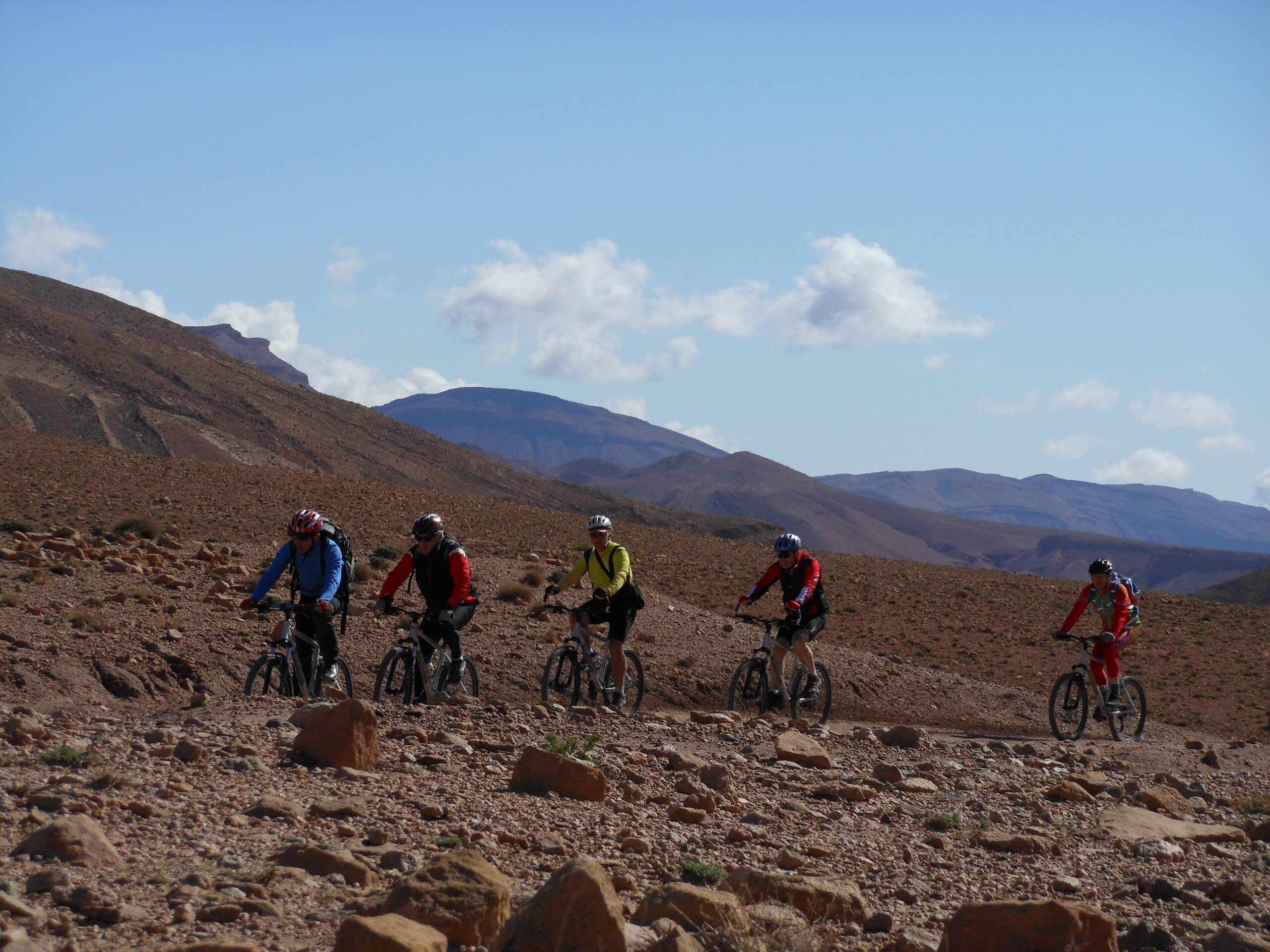 Group of mountain bikers riding the path in Saghro, Morocco
