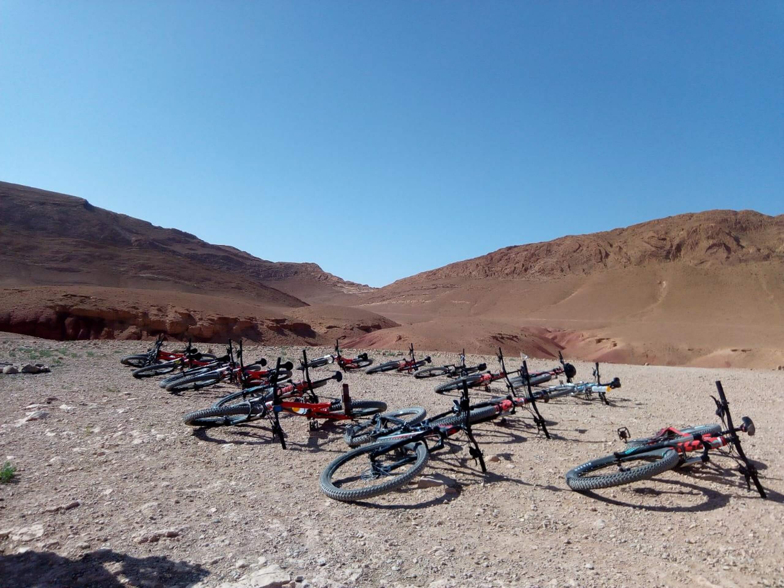Mountain bikes laying on a gravel path in Morocco