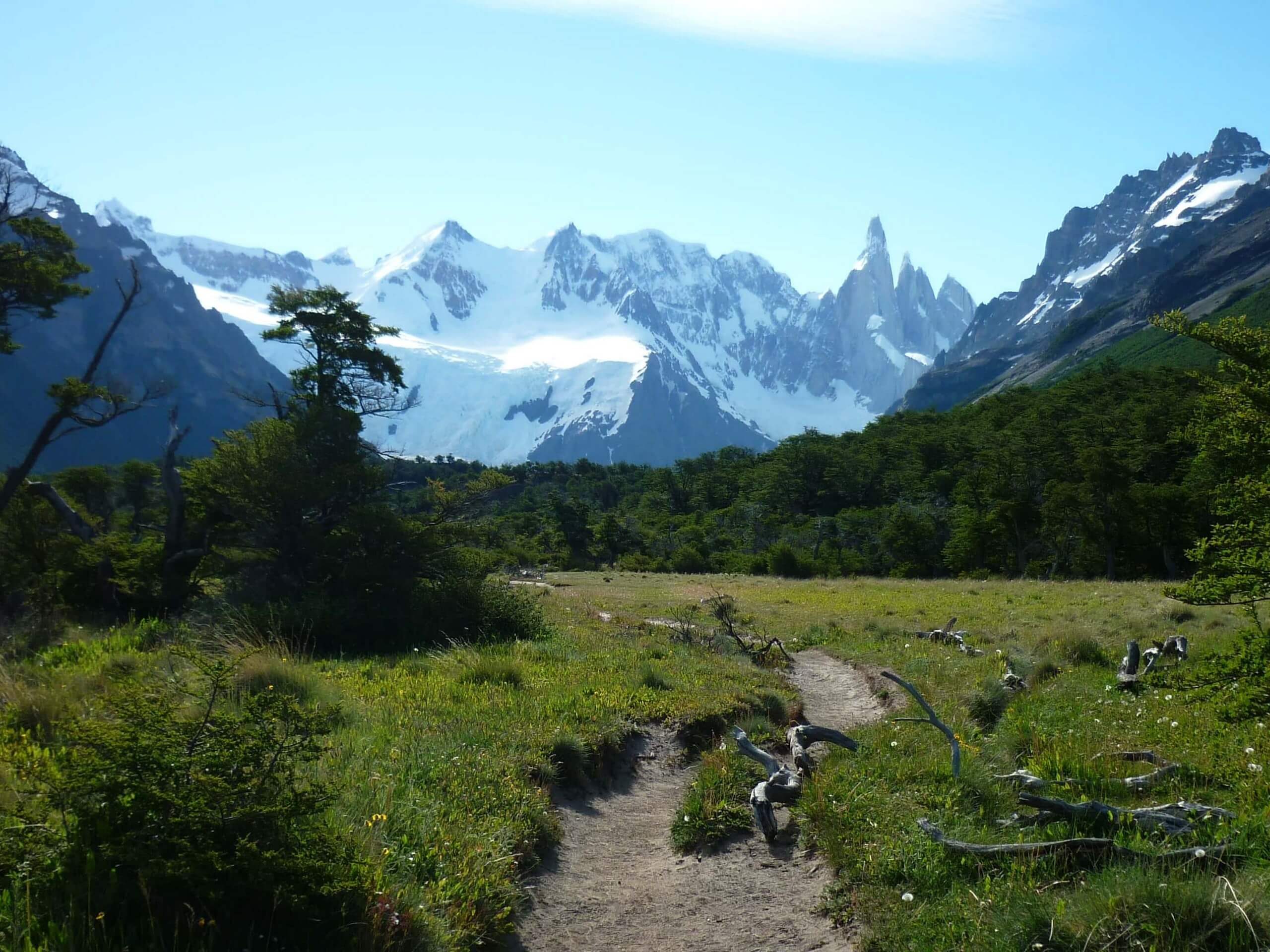 Walking the wide green valley in Patagonia while on guided tour