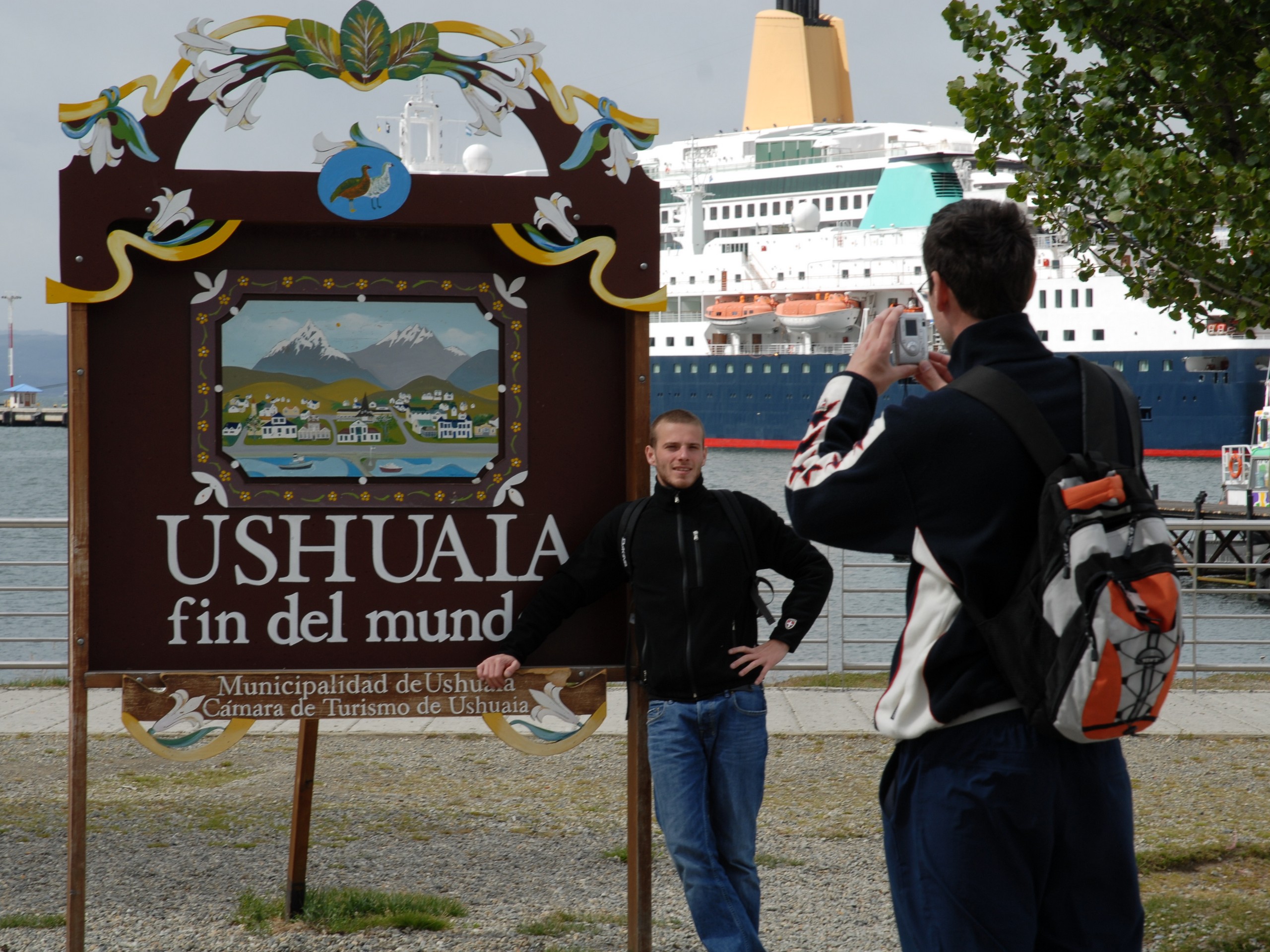 Posing near the sign in the harbor of Ushuaia