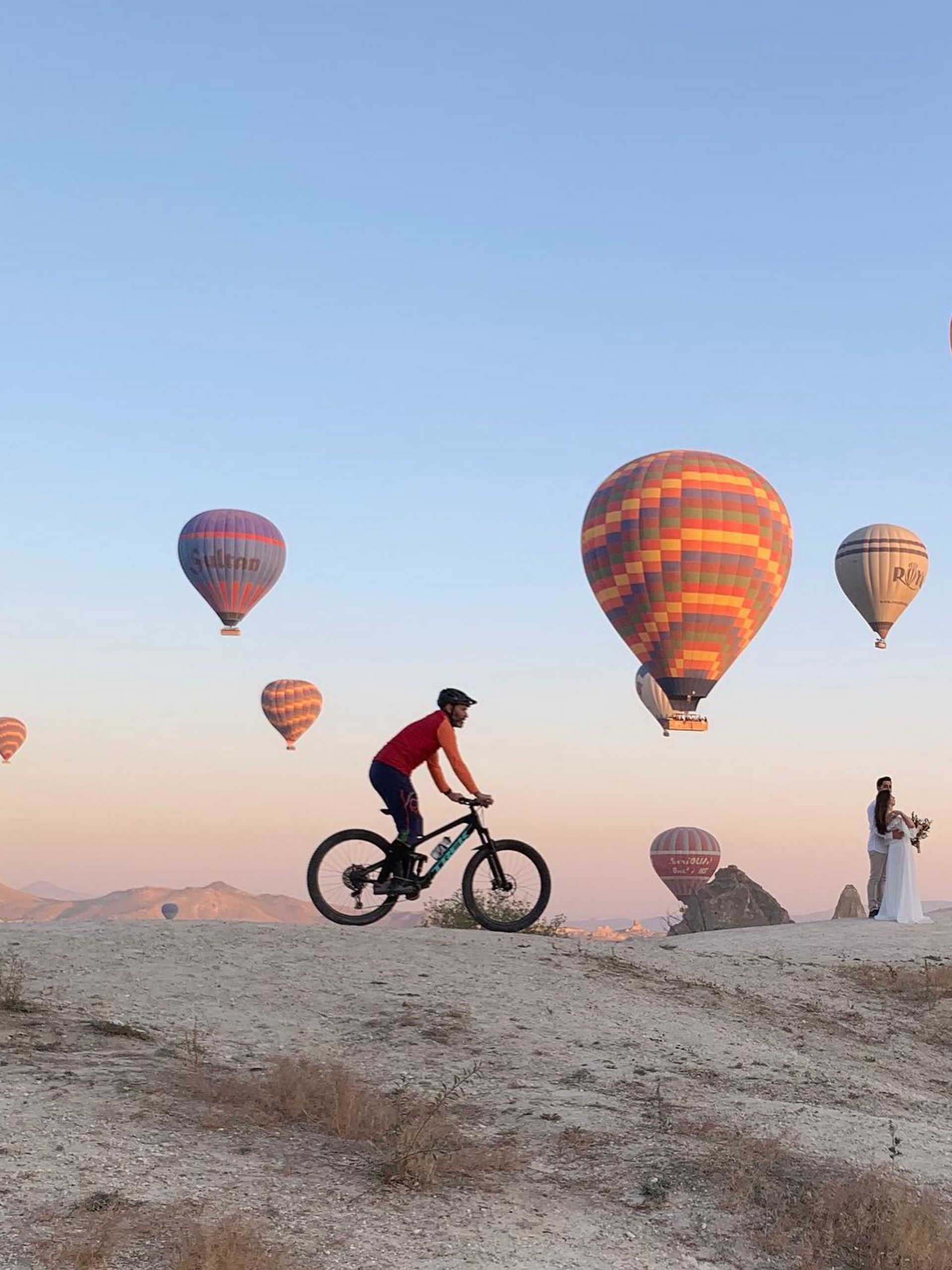 Biker with hot air baloons behind him