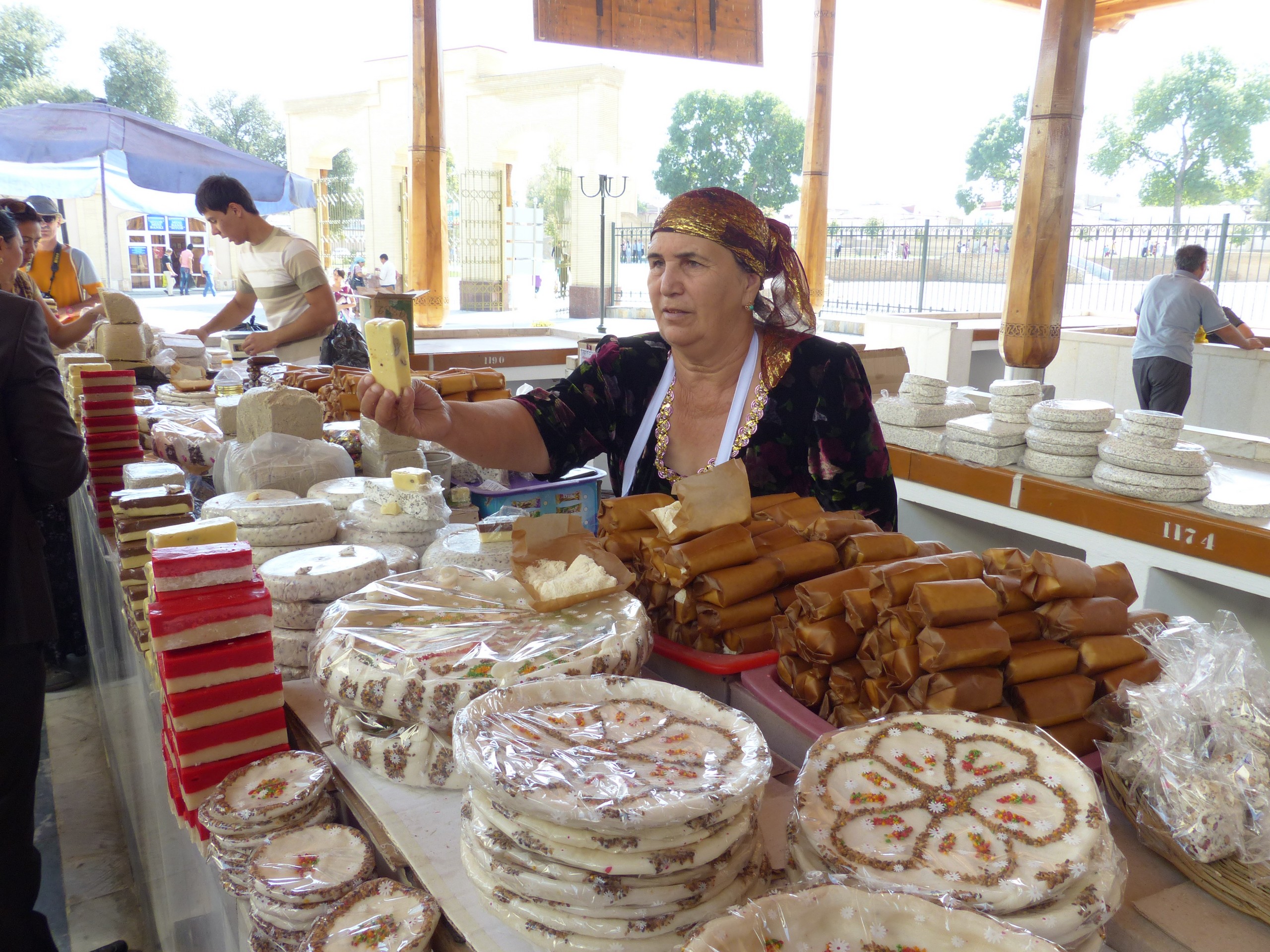Lady in a market selling local Uzbek goods