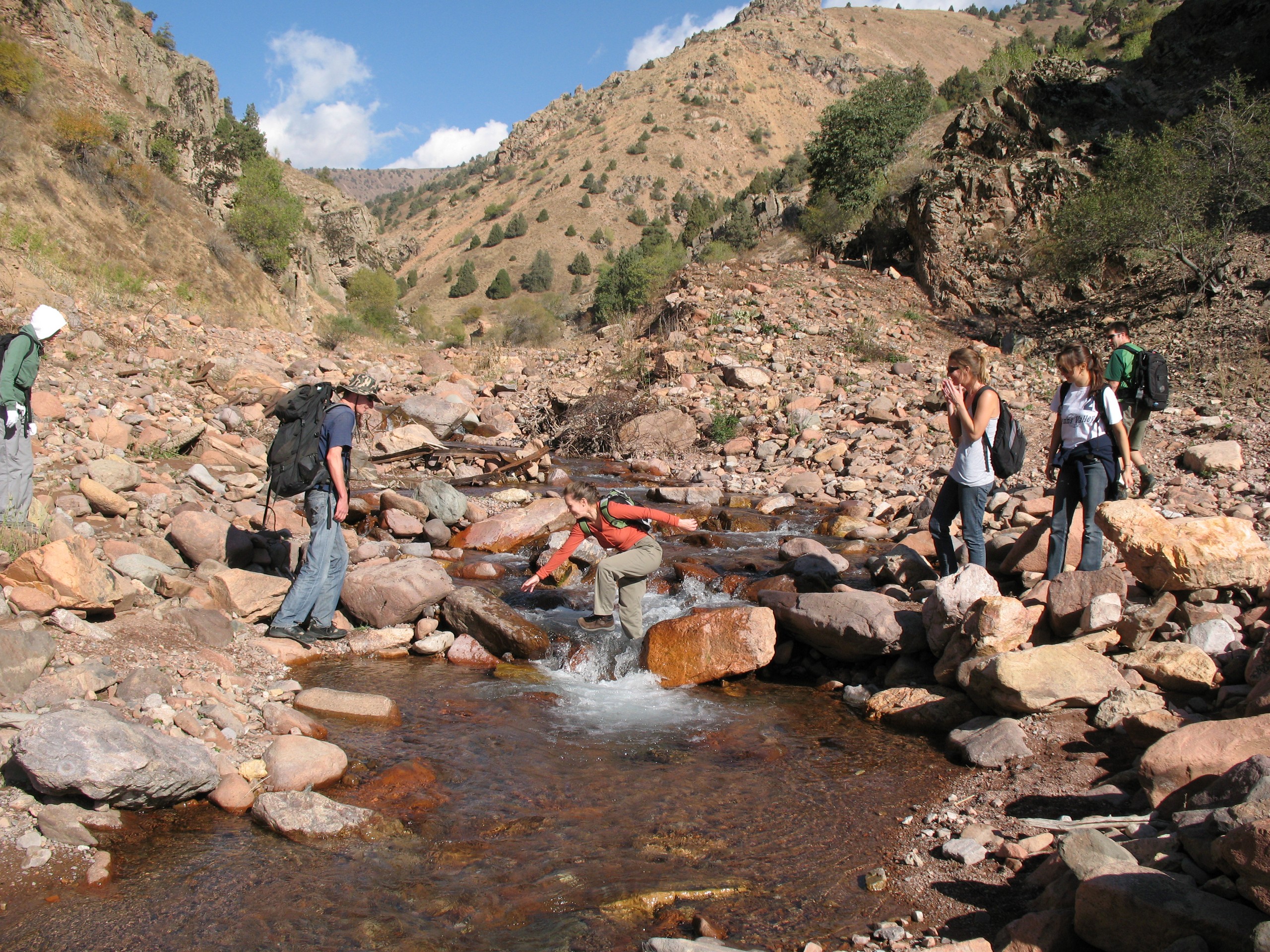 Crossing the creek while on a hike in Uzbekistan