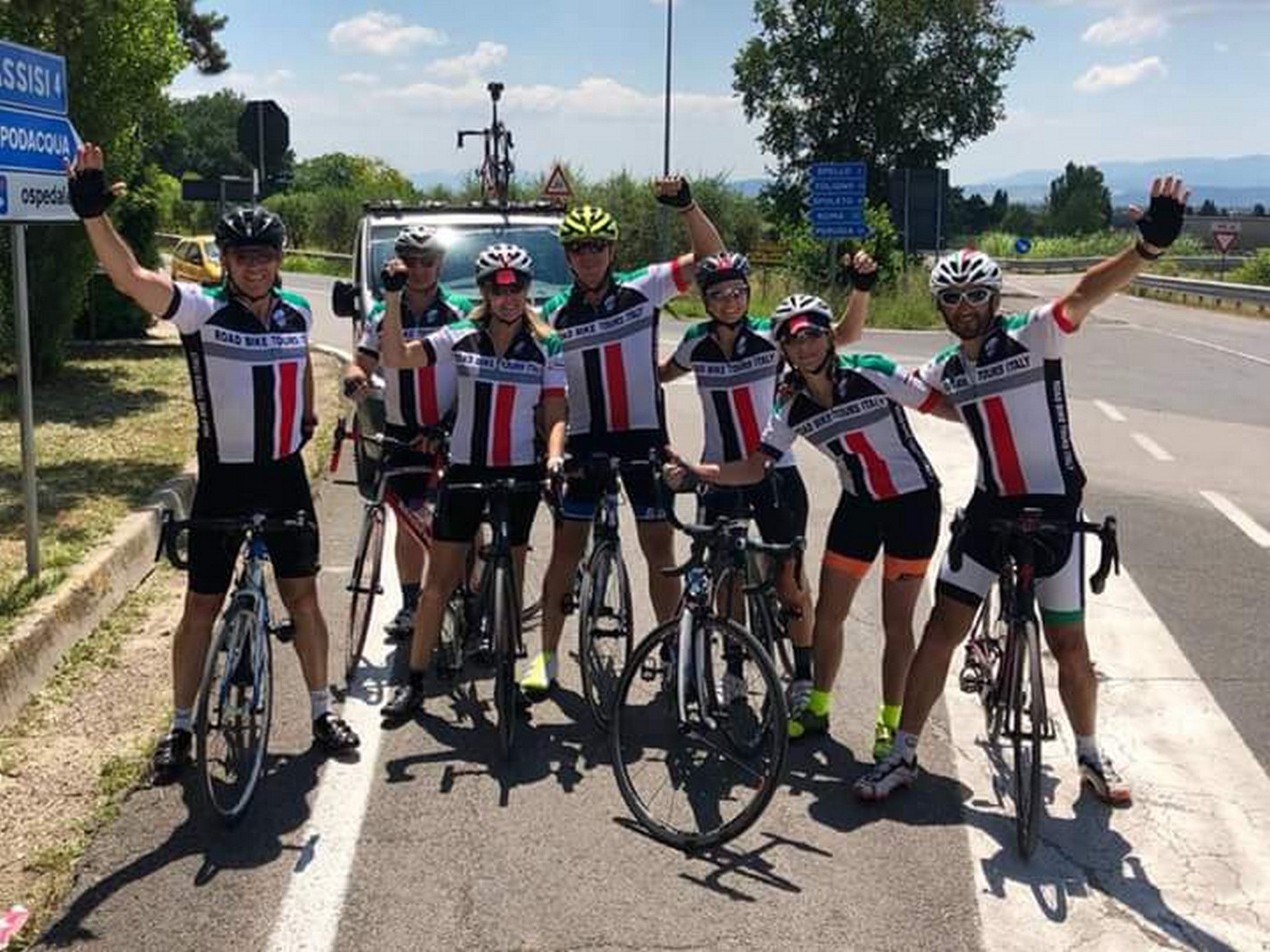 Group of cyclists posing on a guided coast to coast tour in Italy