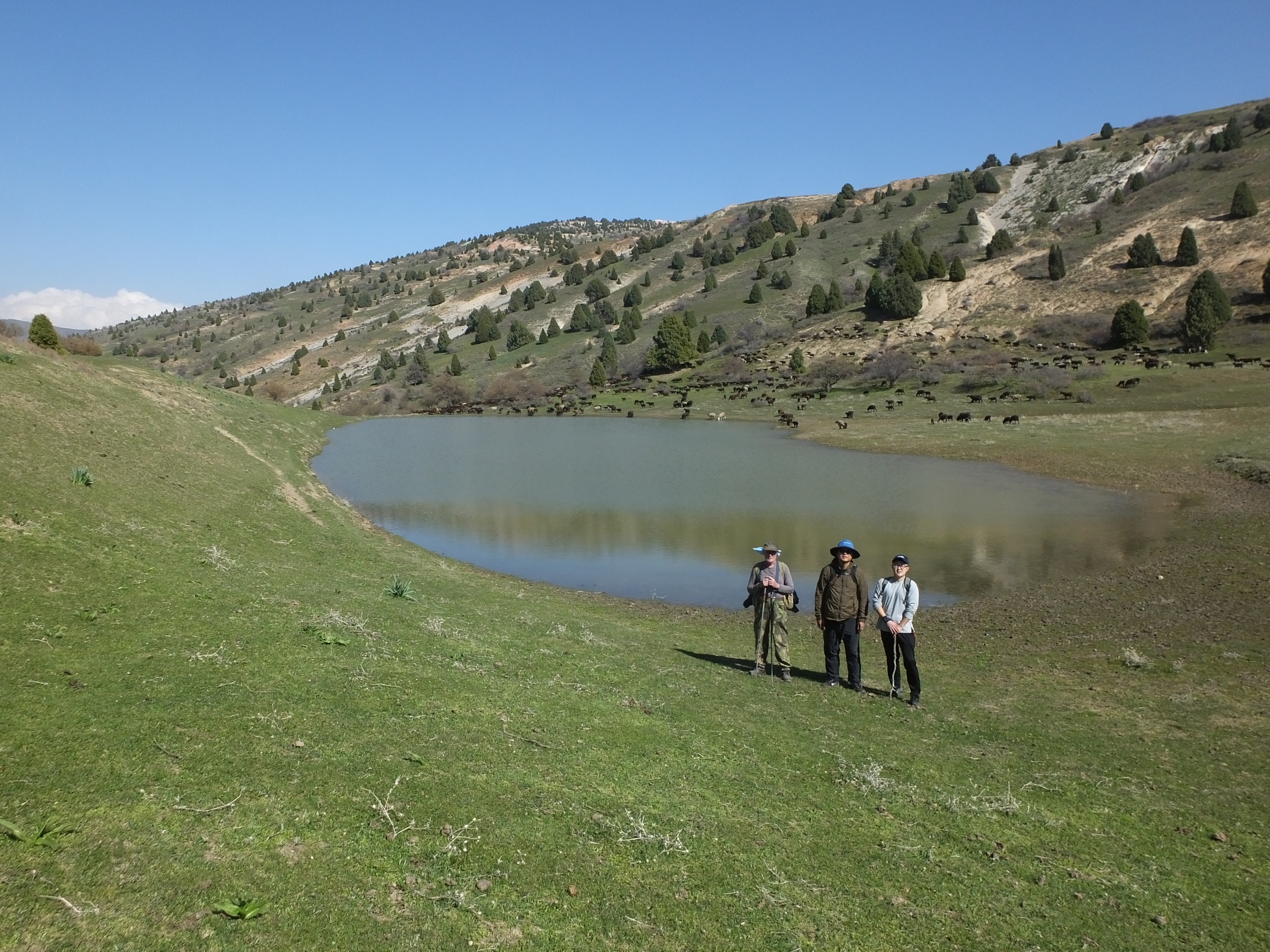 Three hikers posing near the lake in Uzbekistan