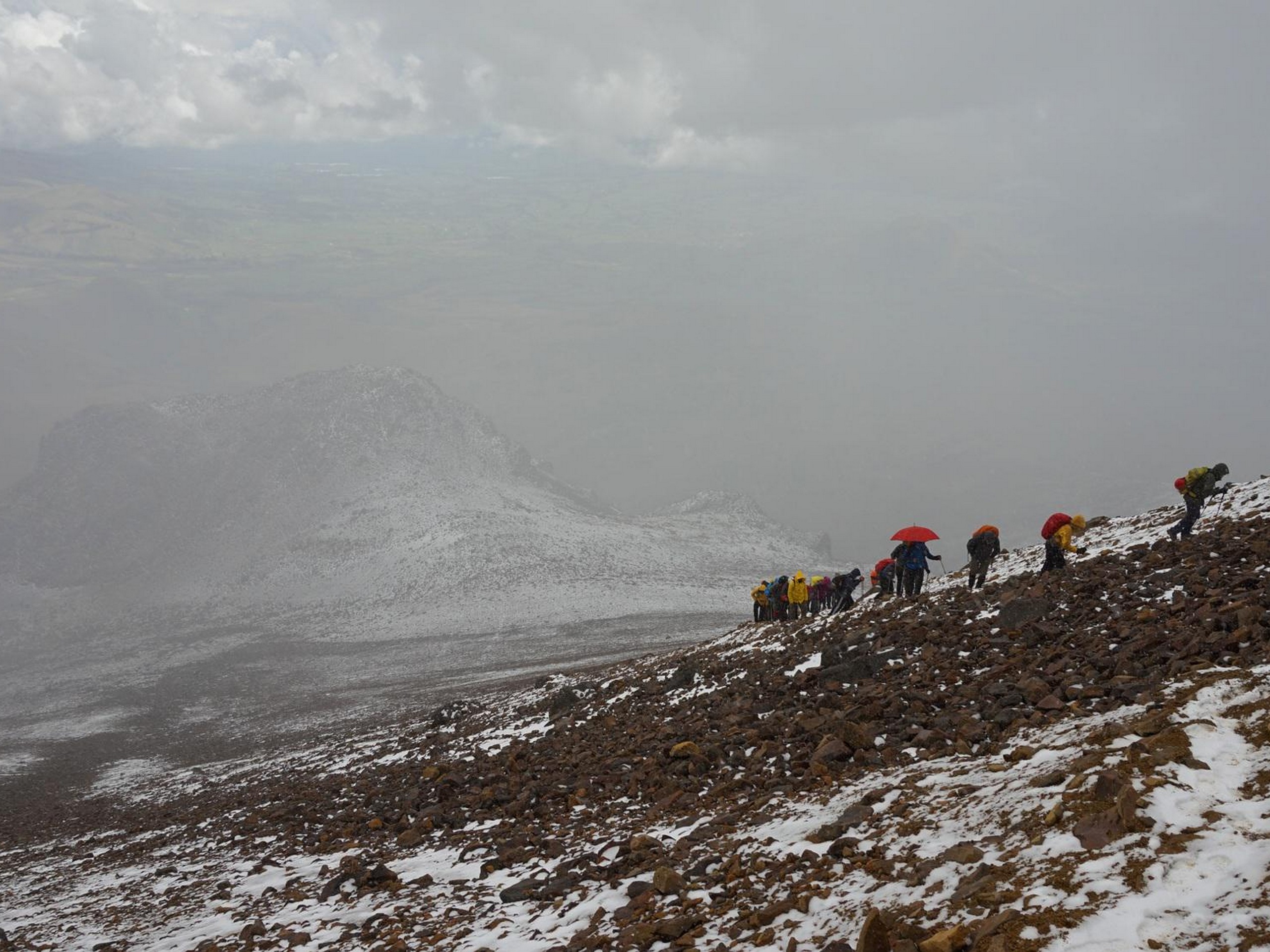 Group of hikers ascending the volcano in Ecuador