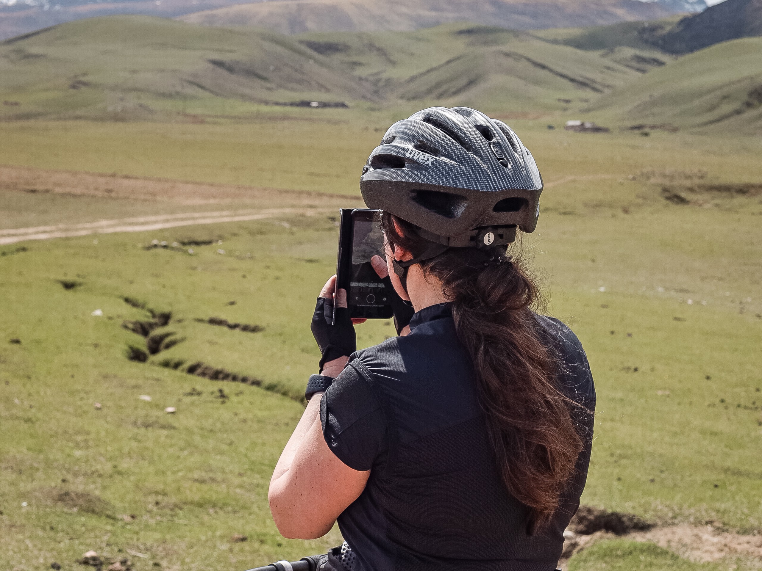 Cyclist taking pictures in Kyrgyzstan