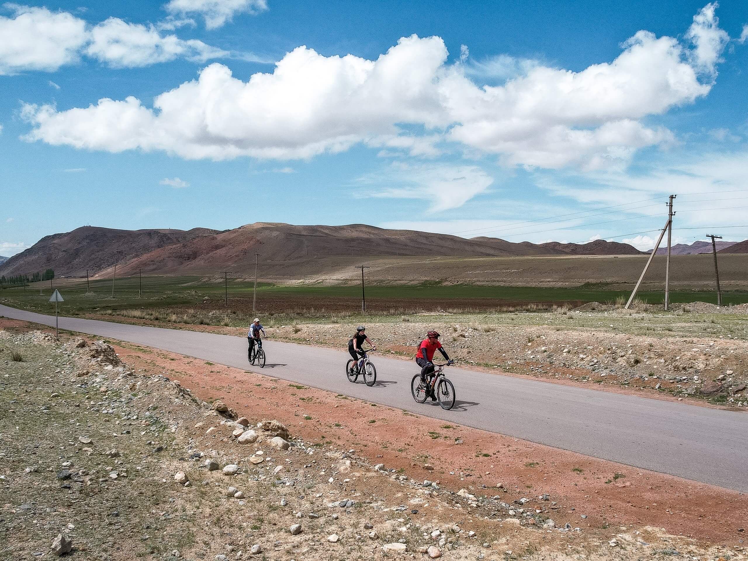 Three cyclists riding the trail in Kyrgyzstan