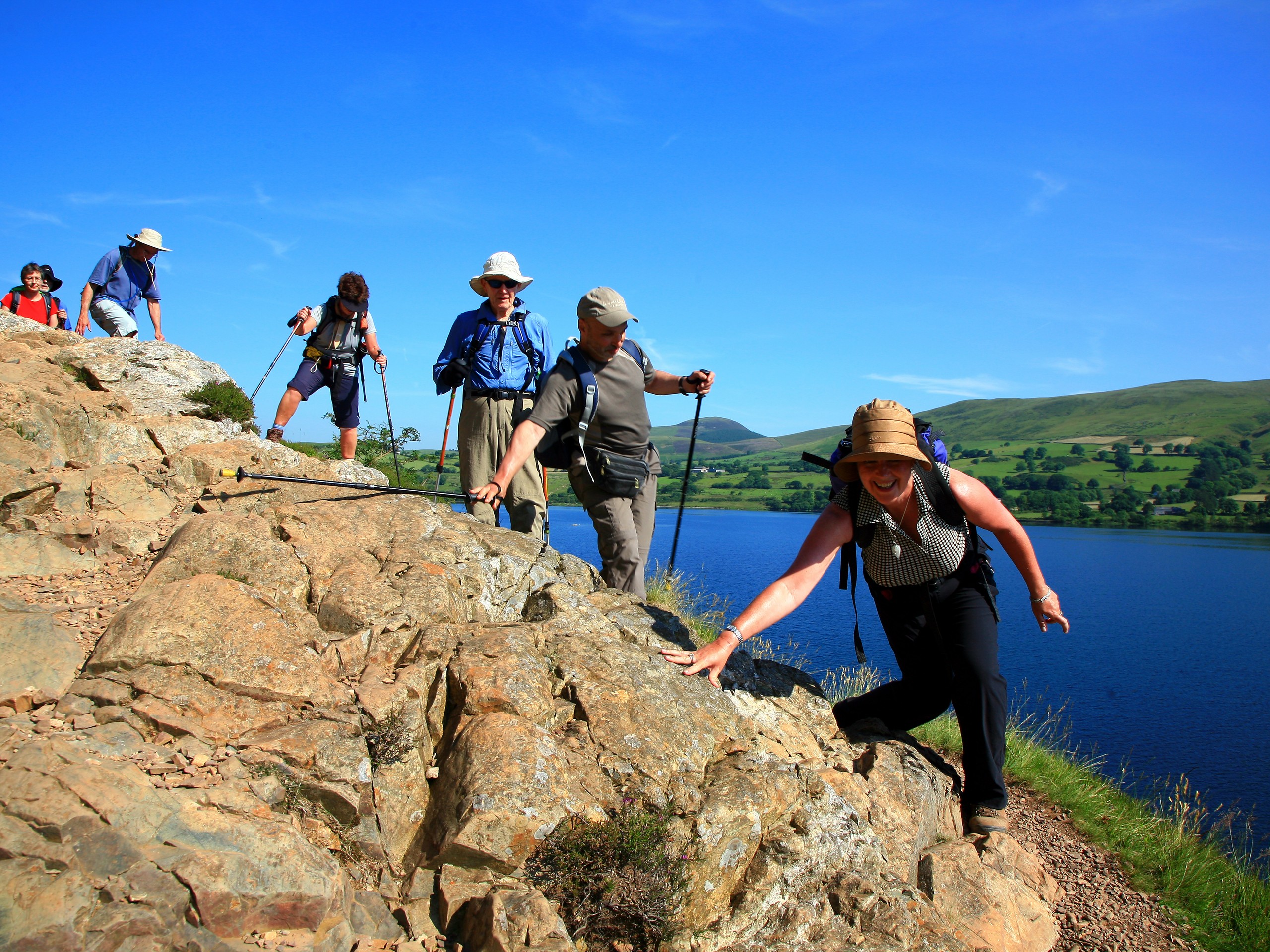 Group of walkers hiking along the lake in the Northern England (c)John Millen