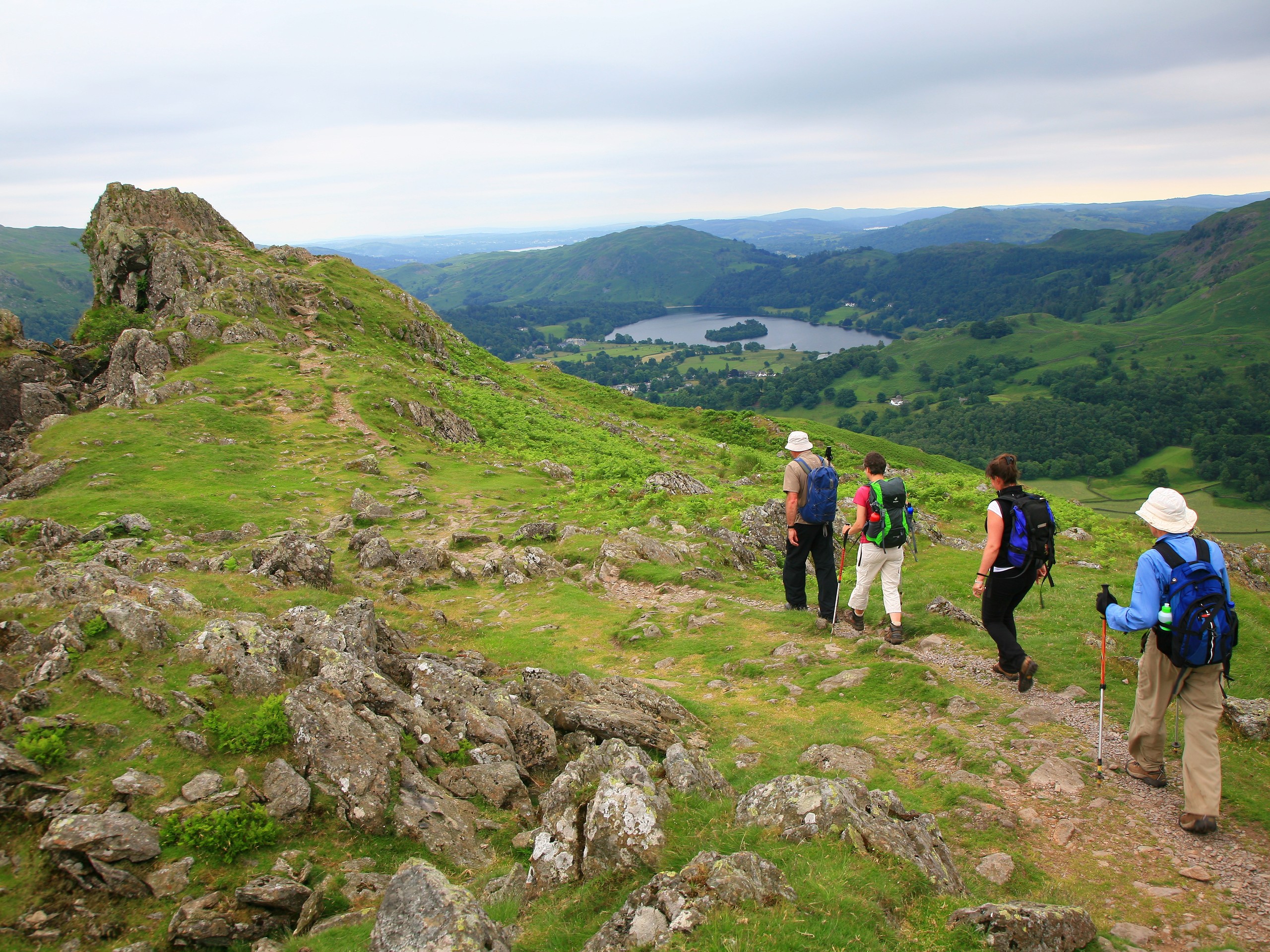 Group of walkers on Helm Crag with Grasmere lake in the background (c)John Millen