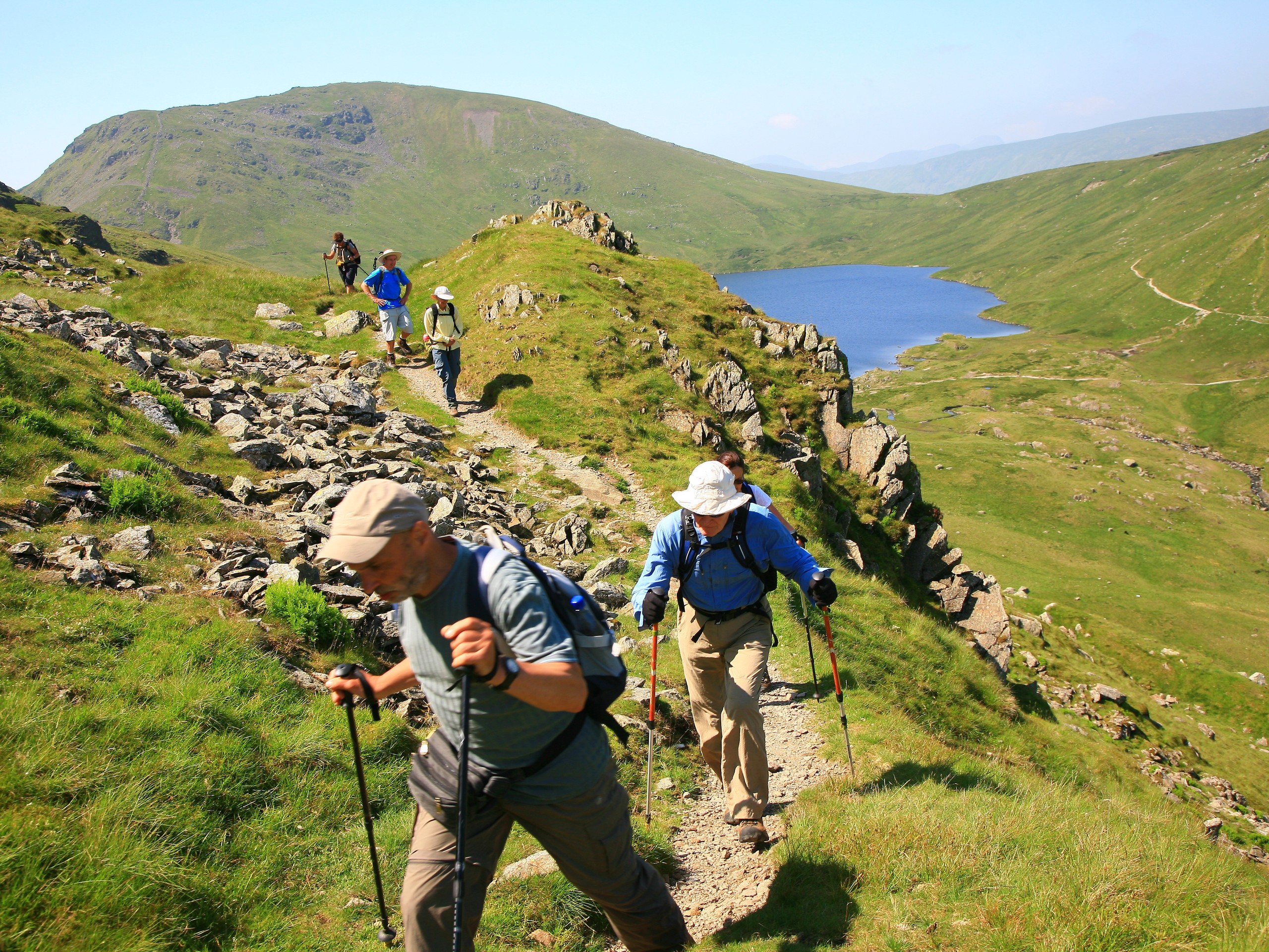 Walking with stunning views behind in the Lake District(c)John Millen