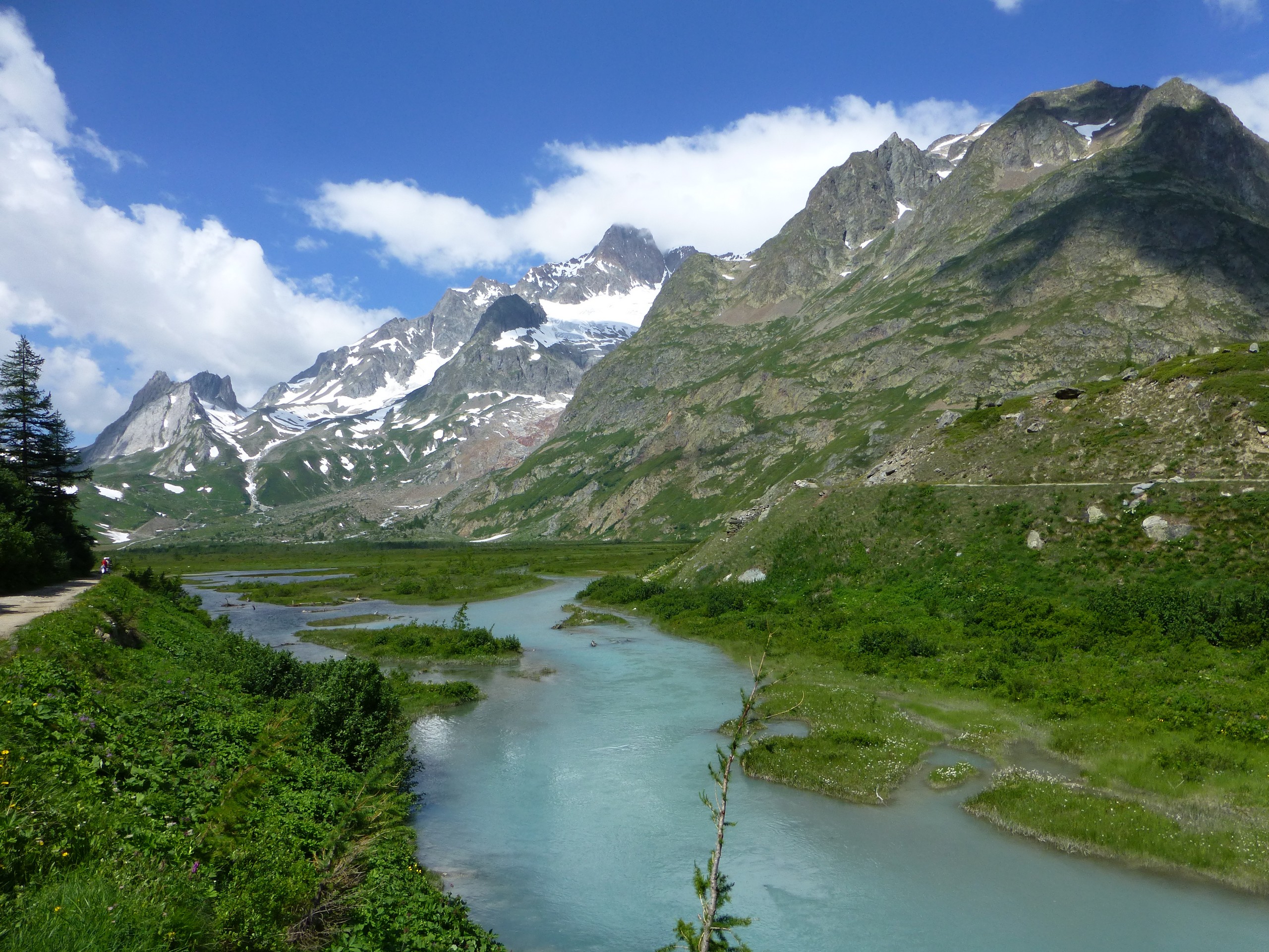 Walking along the beautiful valley in French Alps along the Tour du Mont Blanc route