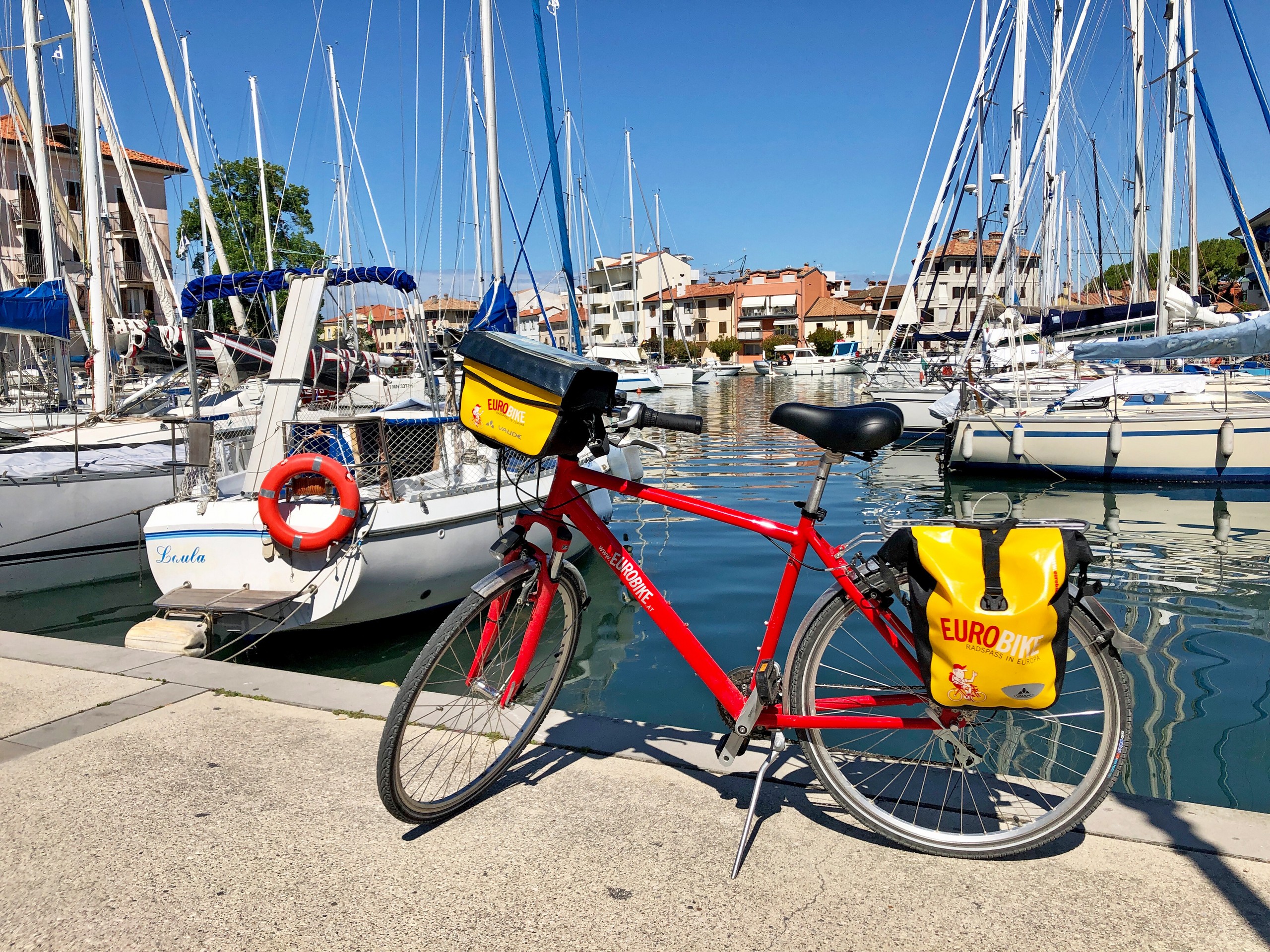 Bike parked near marina in one of the villages along the Alpe Adria trail