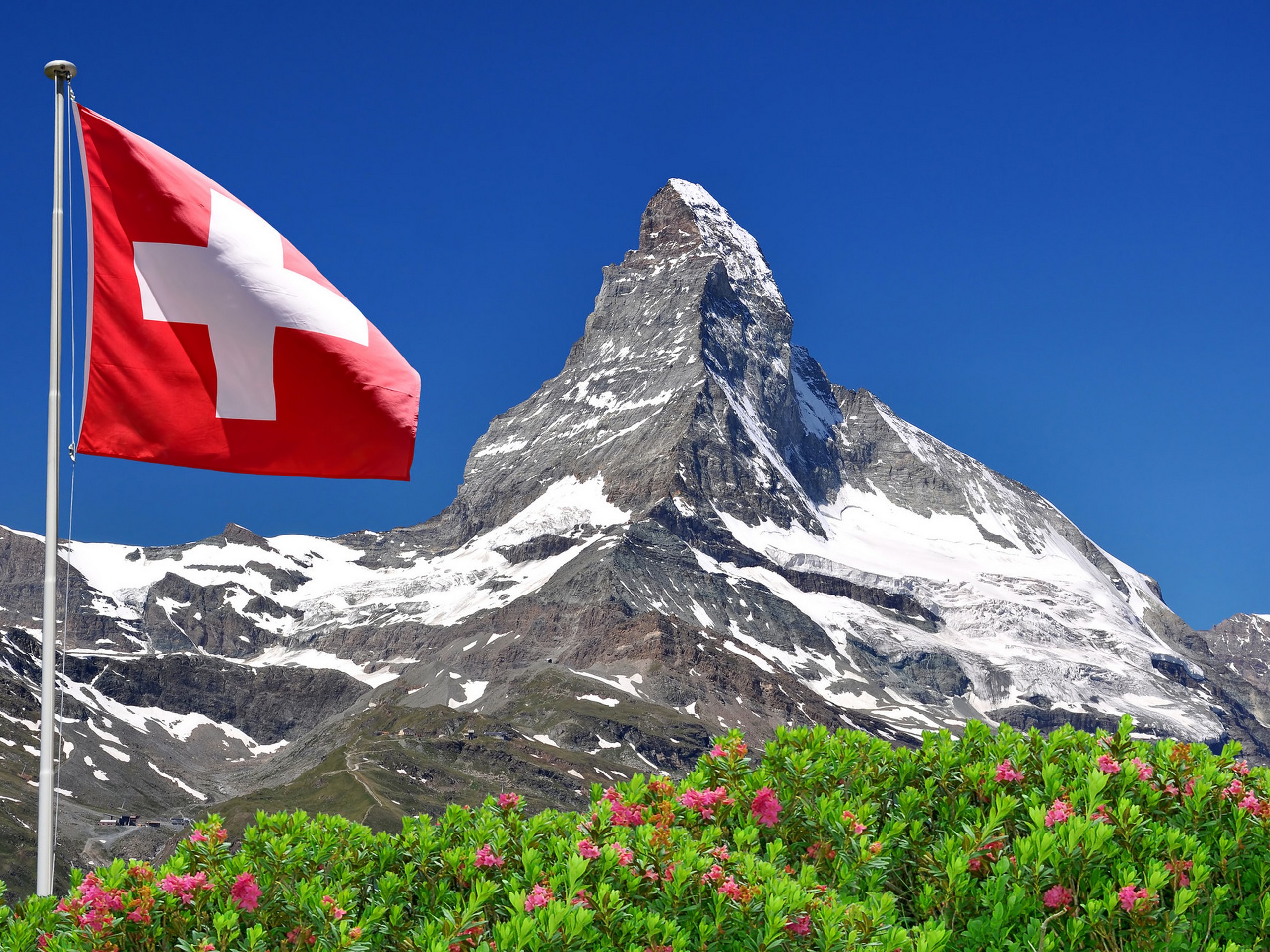 Swiss flag with a beautiful Matterhorn peak behind